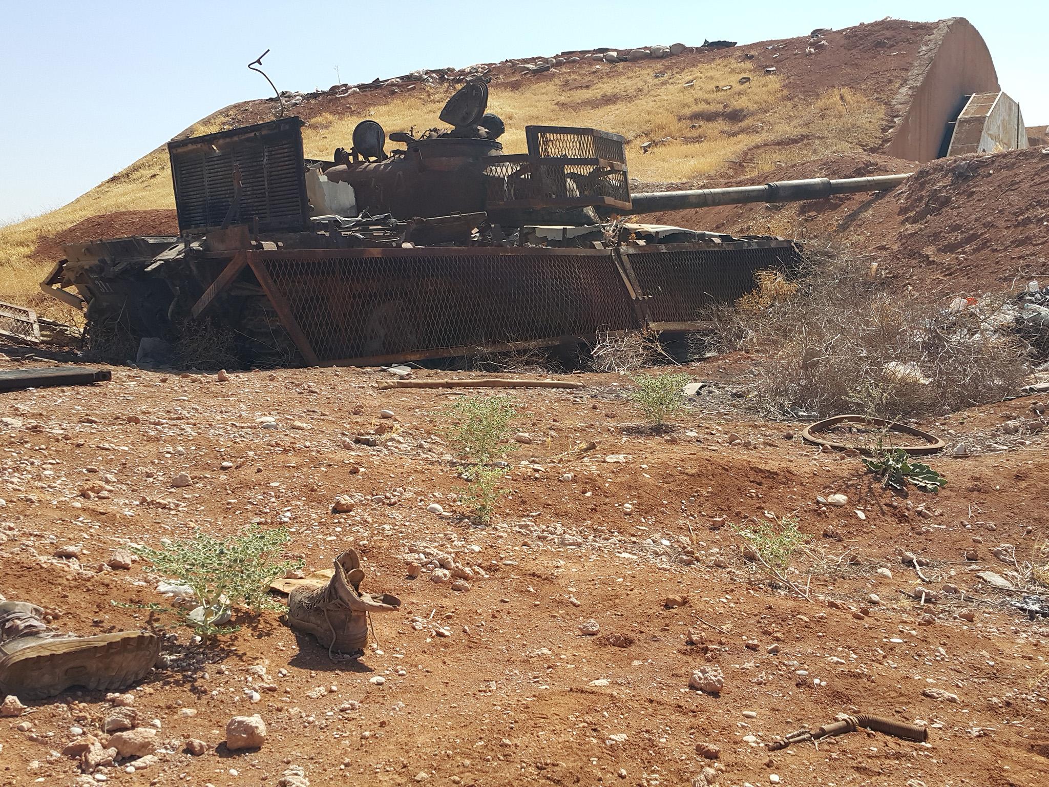 Remains of dead Isis fighters lie beside the wreckage of their suicide tank after they tried to crash through the wall of the Koyeress airbase. Photograph: Nelofer Pazira