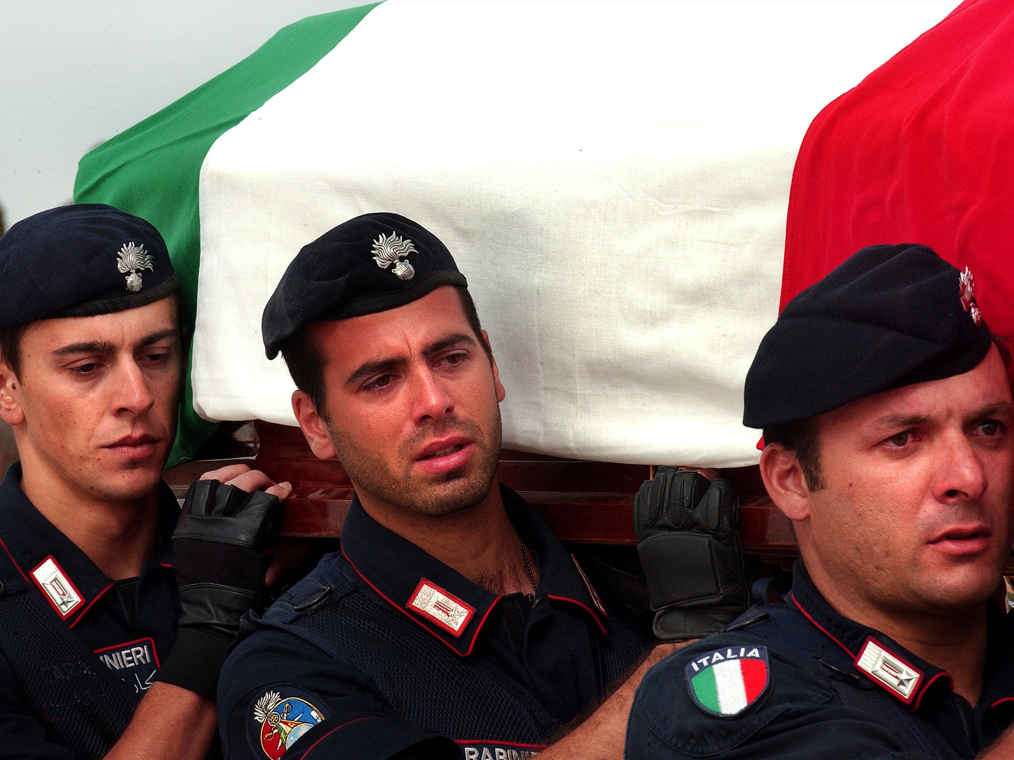 &#13;
Italian carabinieri carry a flag draped coffin of their slain comrade during a November 15, 2003 &#13;