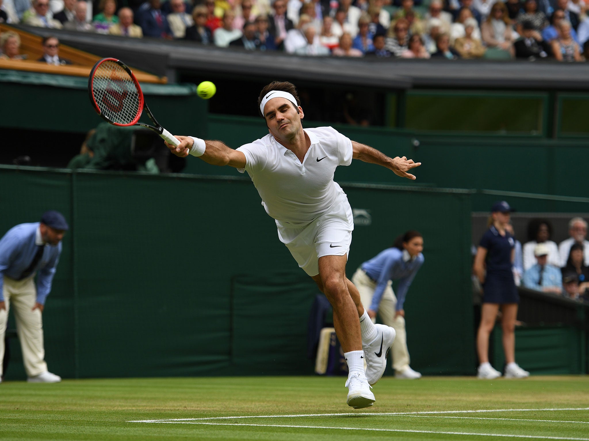 Roger Federer at full stretch during his win over Steve Johnson on Centre Court