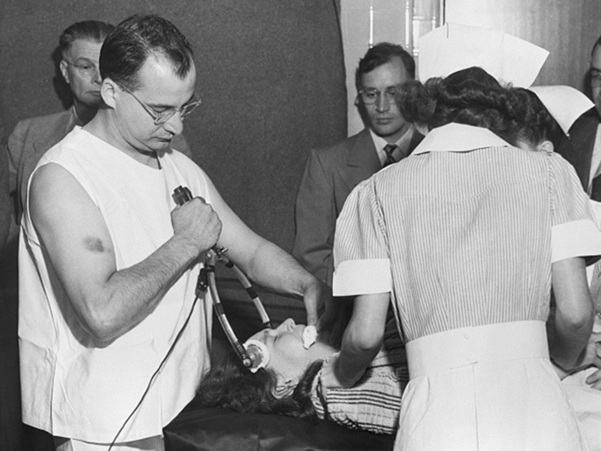 A doctor administers 'transorbital lobotomy' , or shock therapy at Western State Hospital in 1949