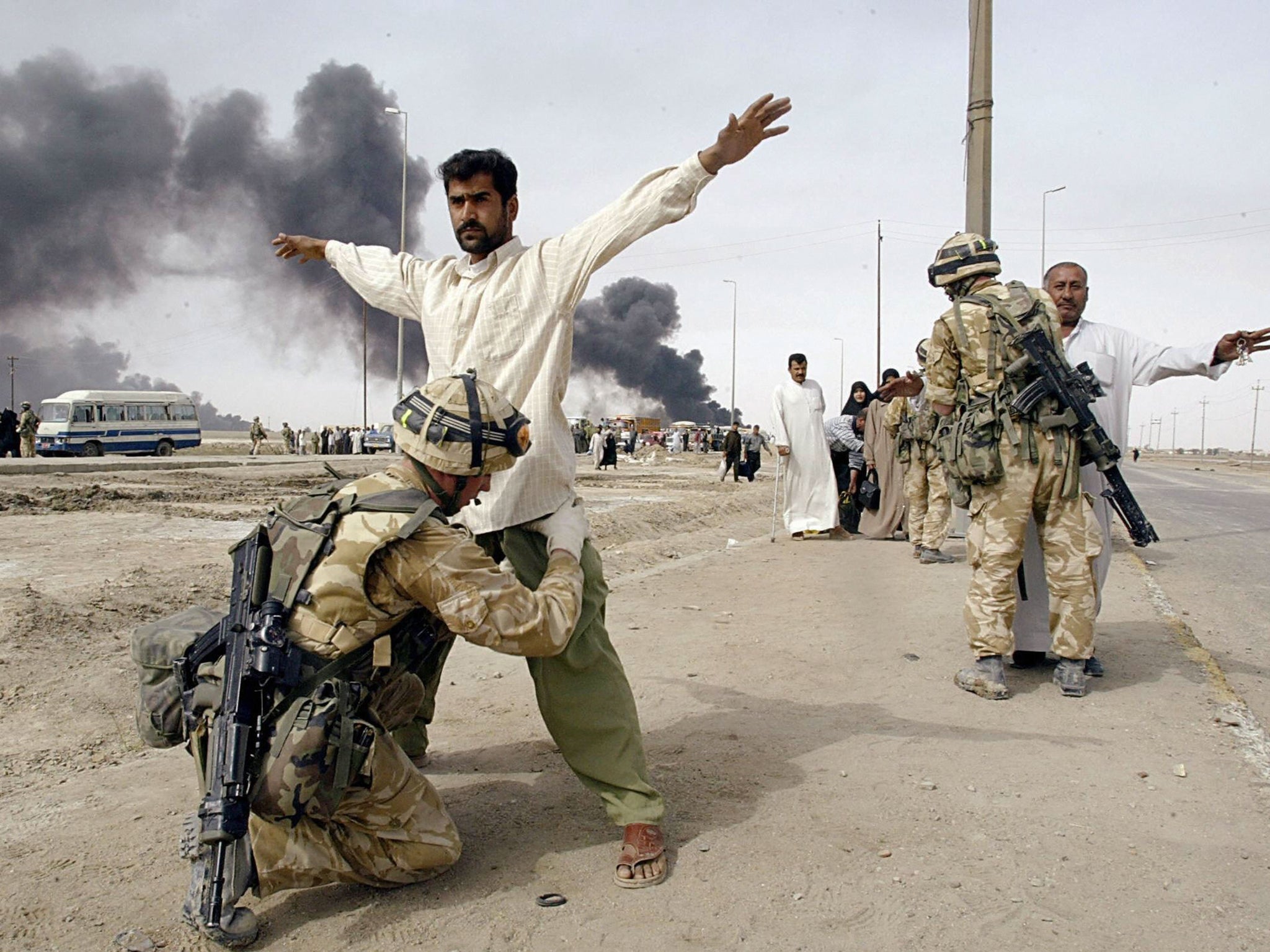 British soldiers check Iraqis leaving Basra in 2003