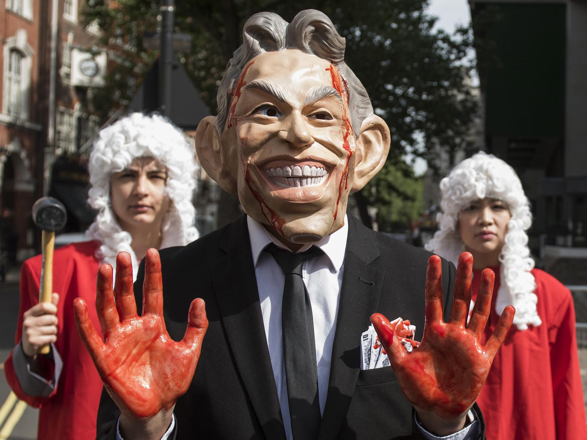 Protesters dressed as Tony Blair hold a demonstration as they wait for the release of the Chilcot Inquiry