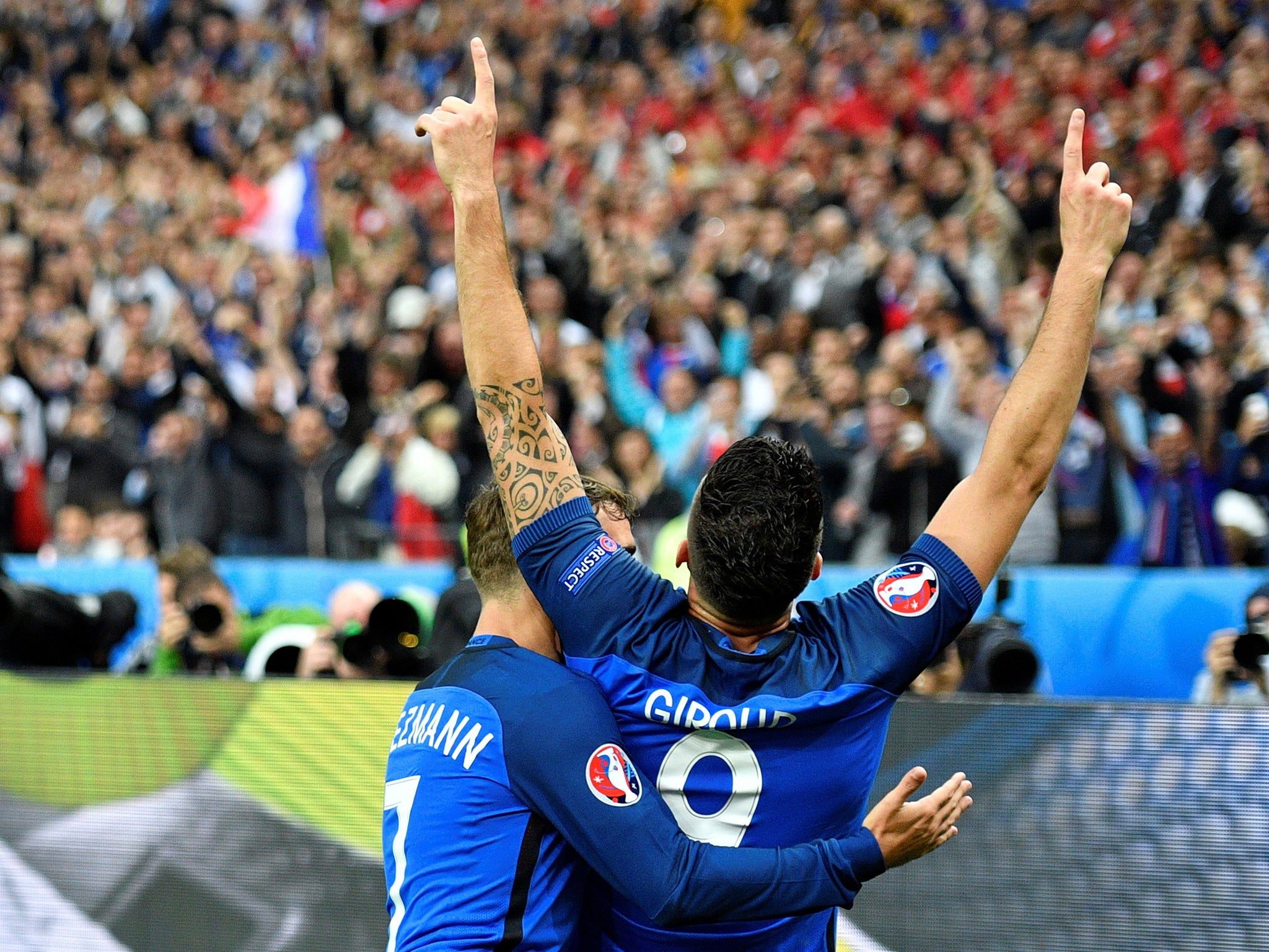 Giroud and Griezmann embrace after the former's opening goal against Iceland