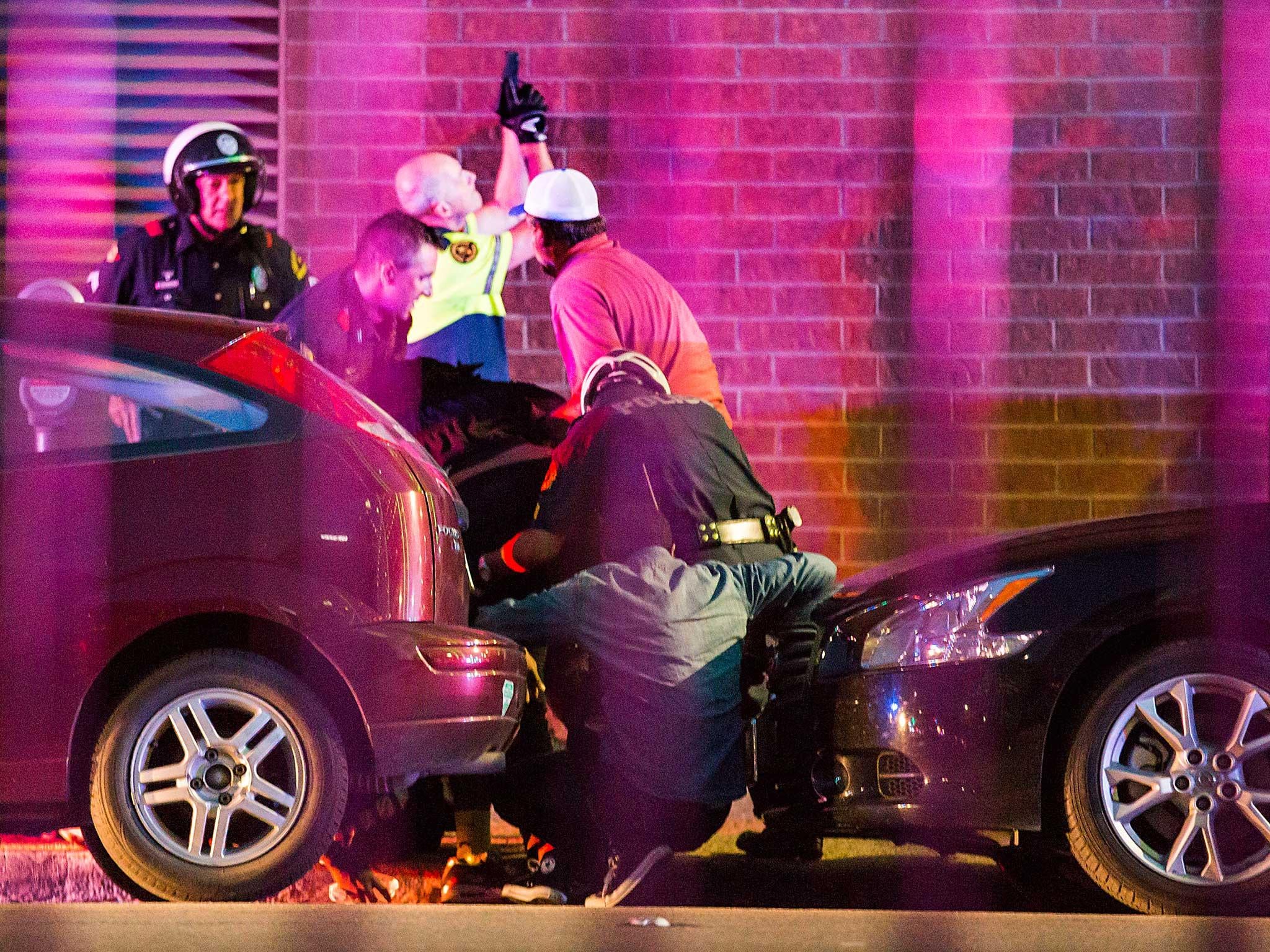 Dallas Police shield bystanders after shots were fired 7 July 2016