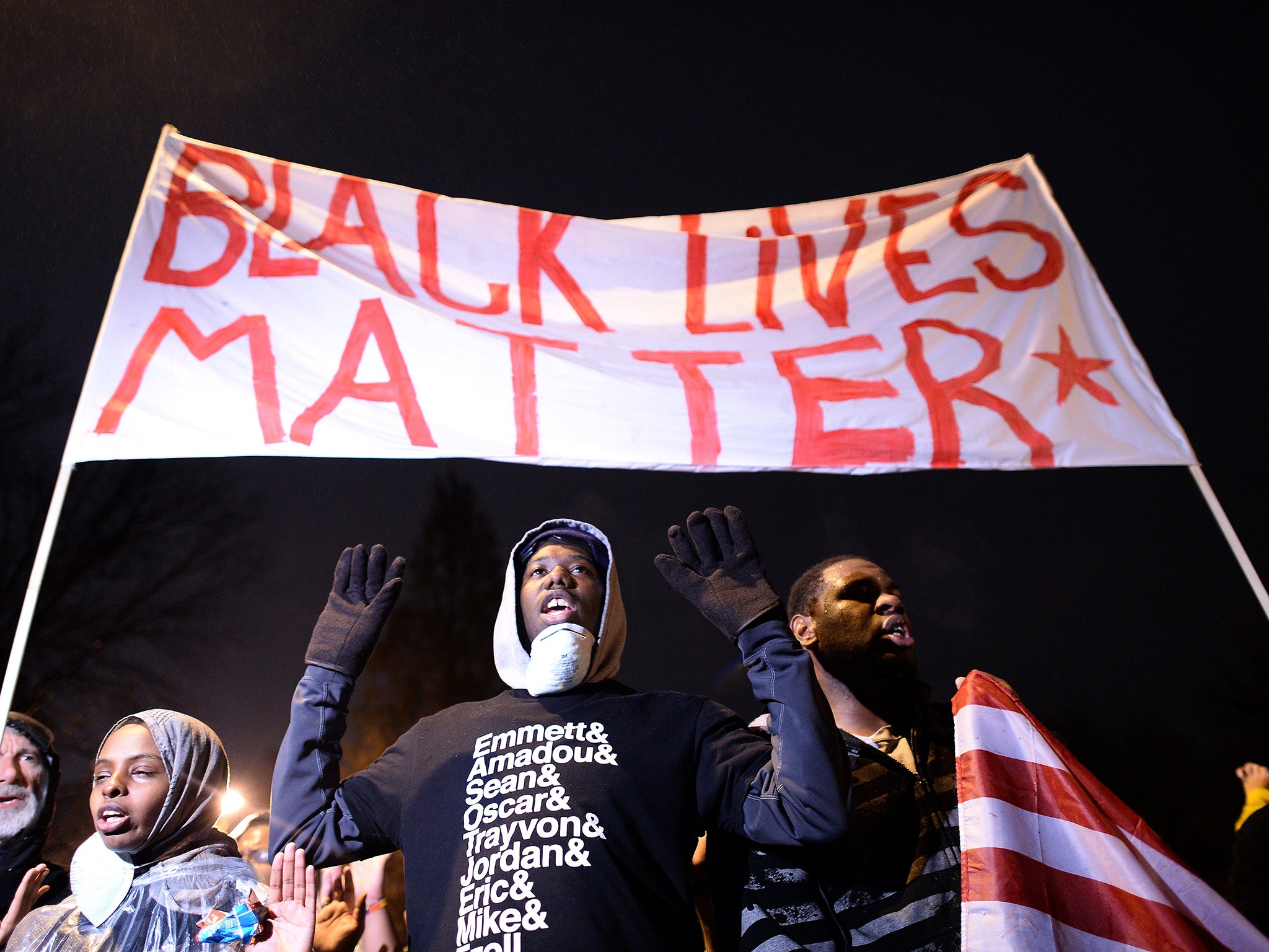 Demonstrators have their 'hands up' at a march protesting the death of 18-year-old Michael Brown in 2014