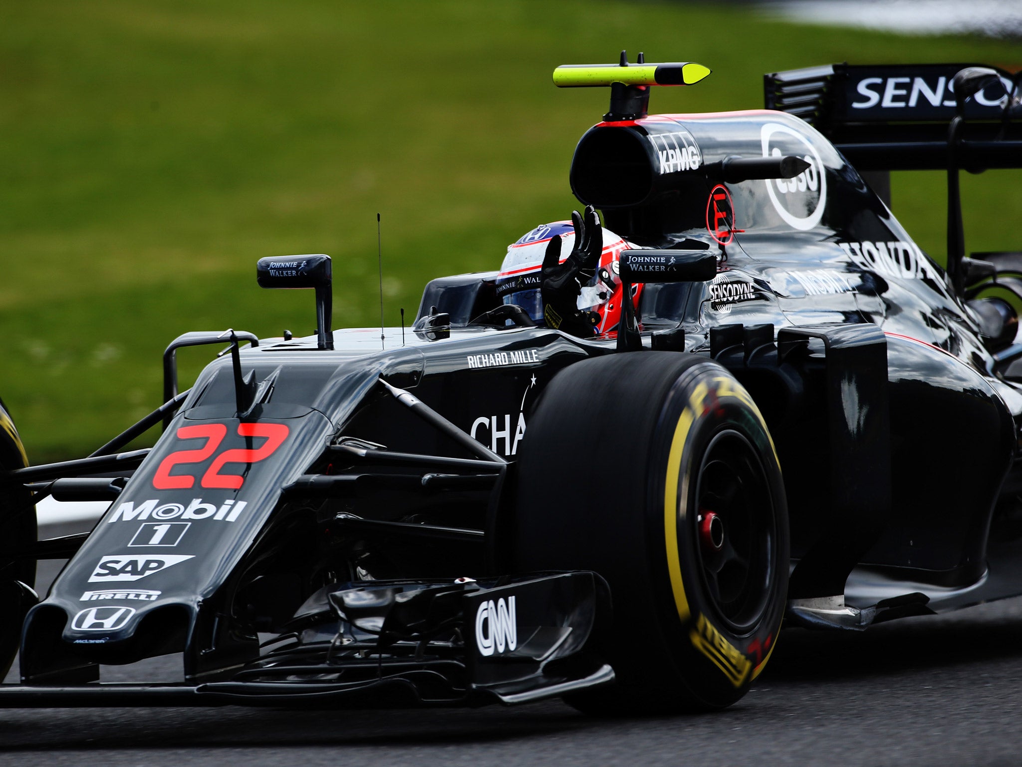 Jenson Button waves to the Silverstone crowd at his home grand prix