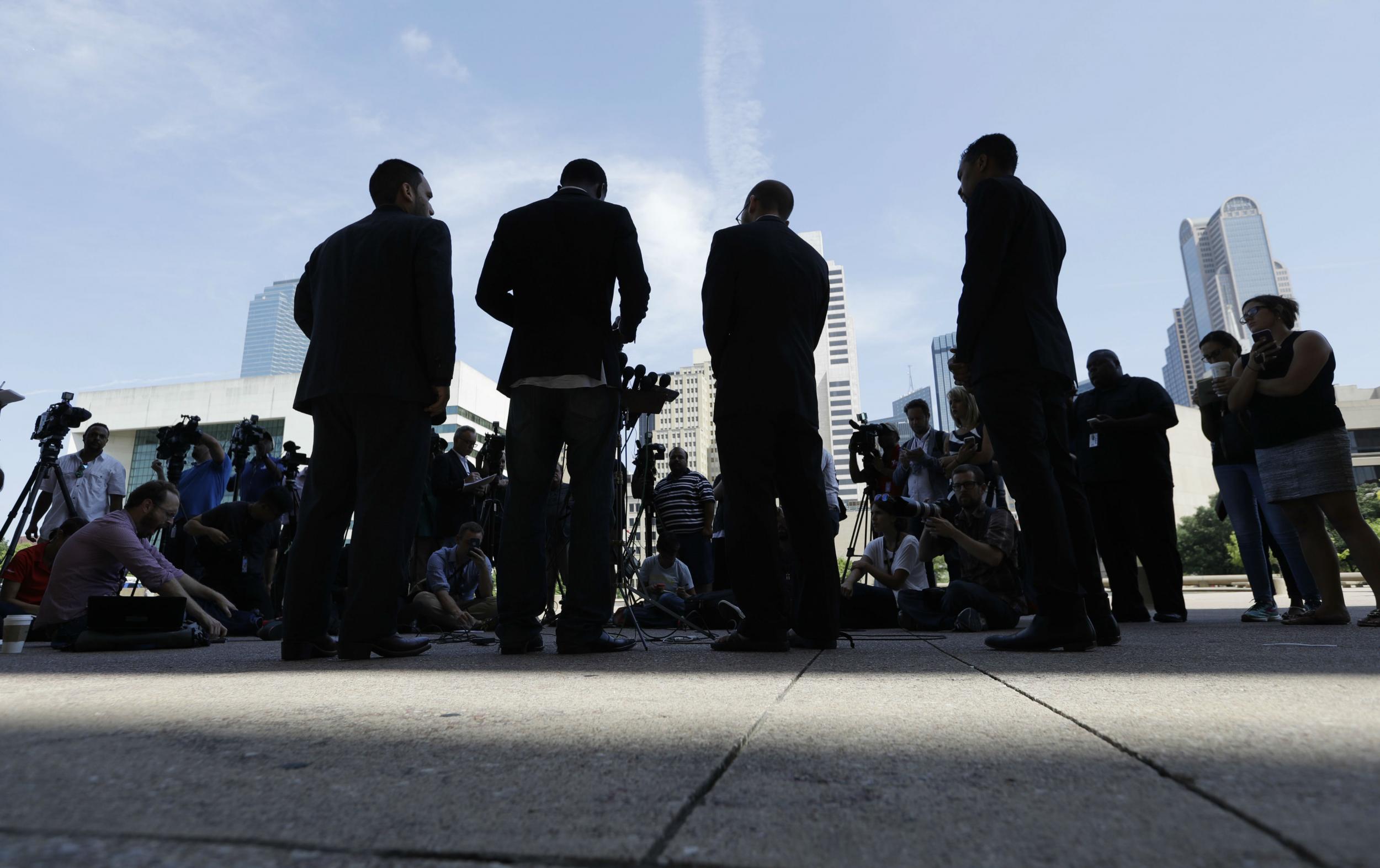 Faith leaders gather to hold a vigil in Dallas