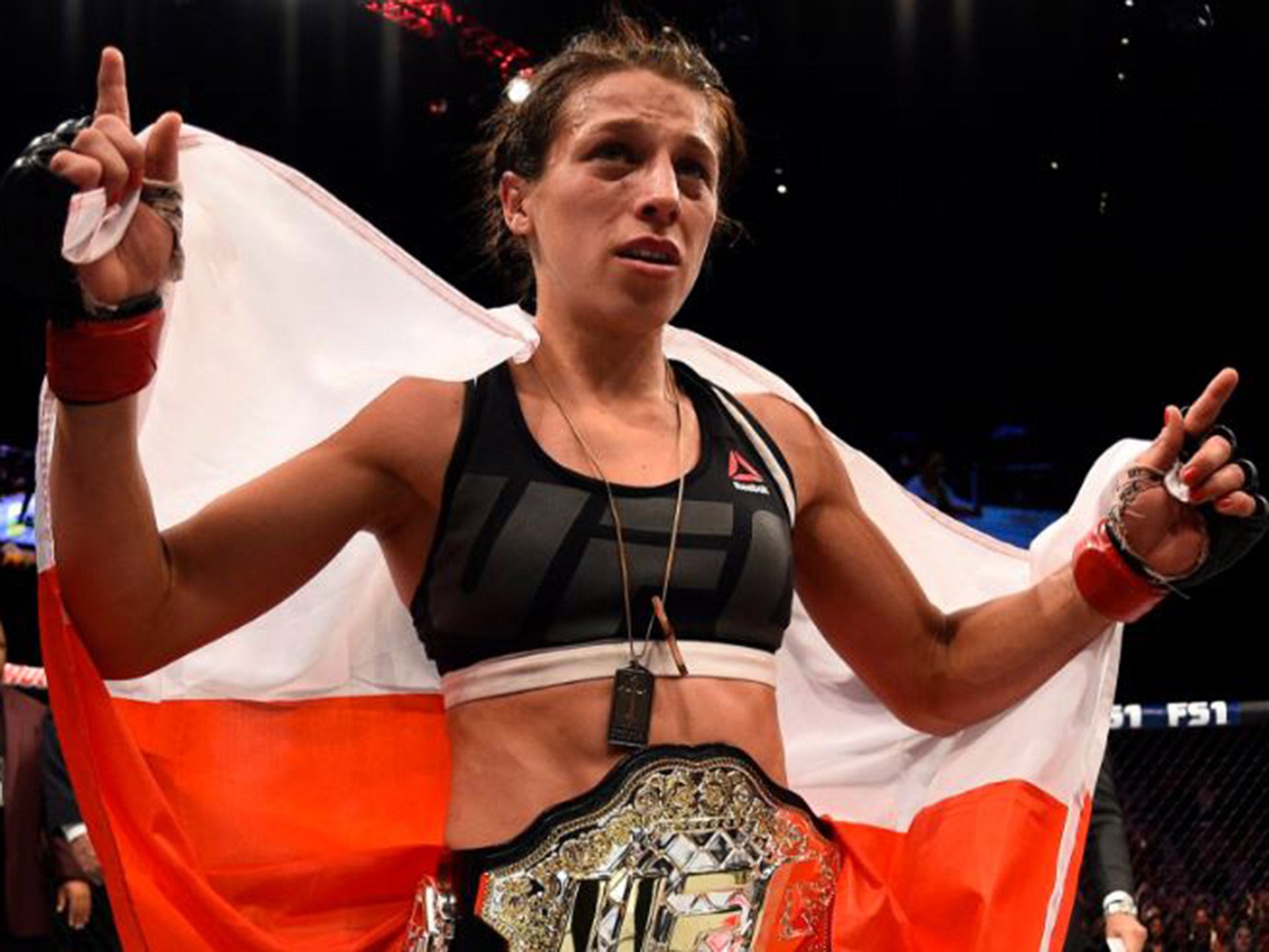 Joanna Jedrzejczyk celebrates retaining her UFC strawweight title