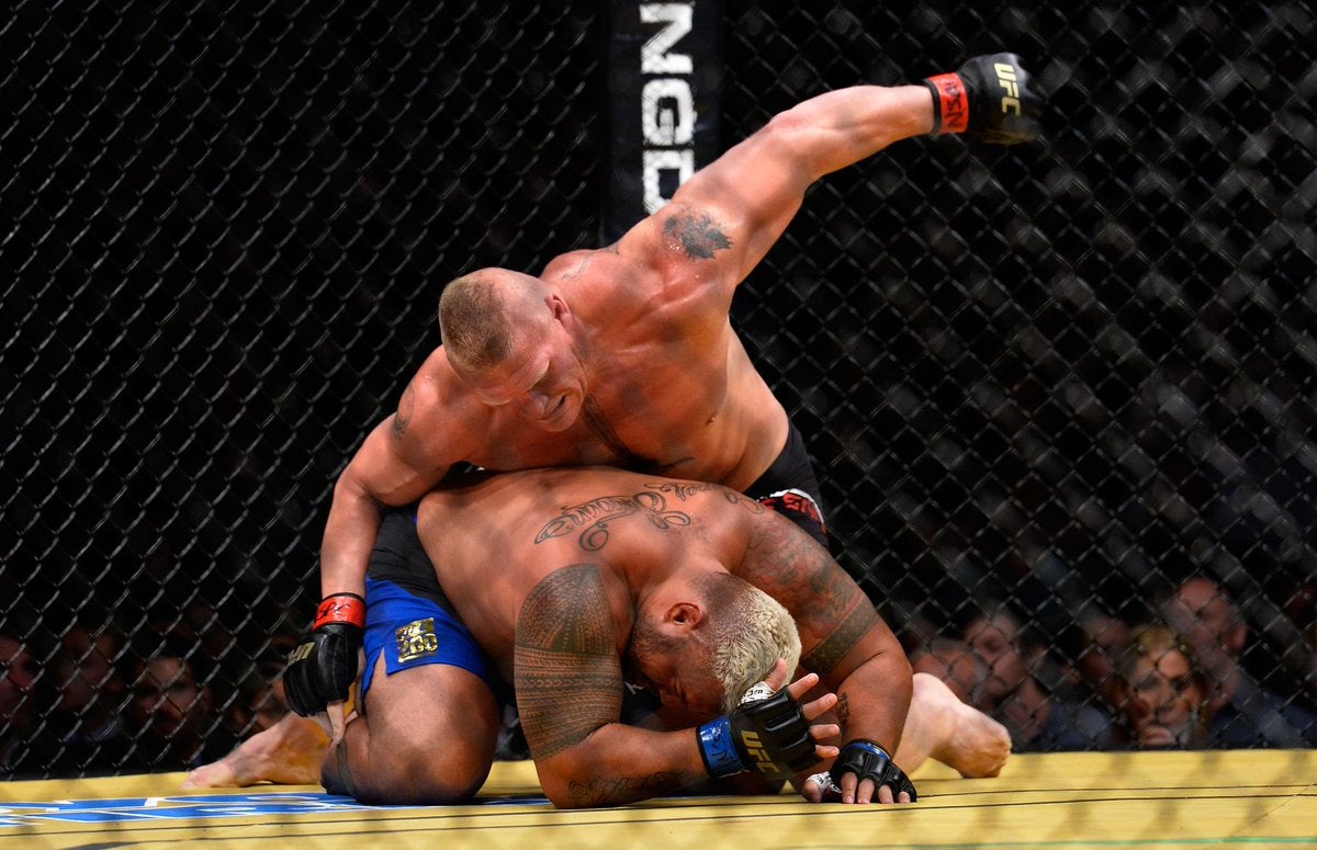 Brock Lesnar delivers a right hand to Mark Hunt