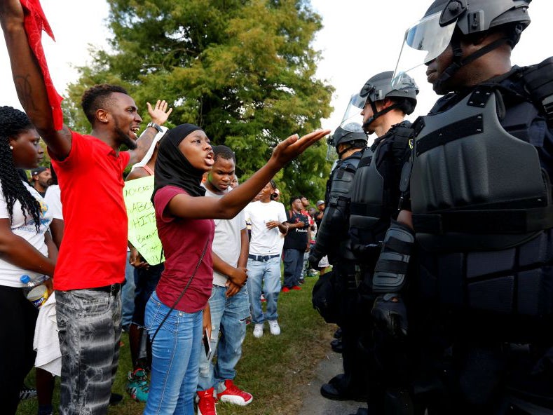 Demonstrators protest the shooting death of Alton Sterling near the headquarters of the Baton Rouge Police Department (Jonathon Bachman/ Reuters )