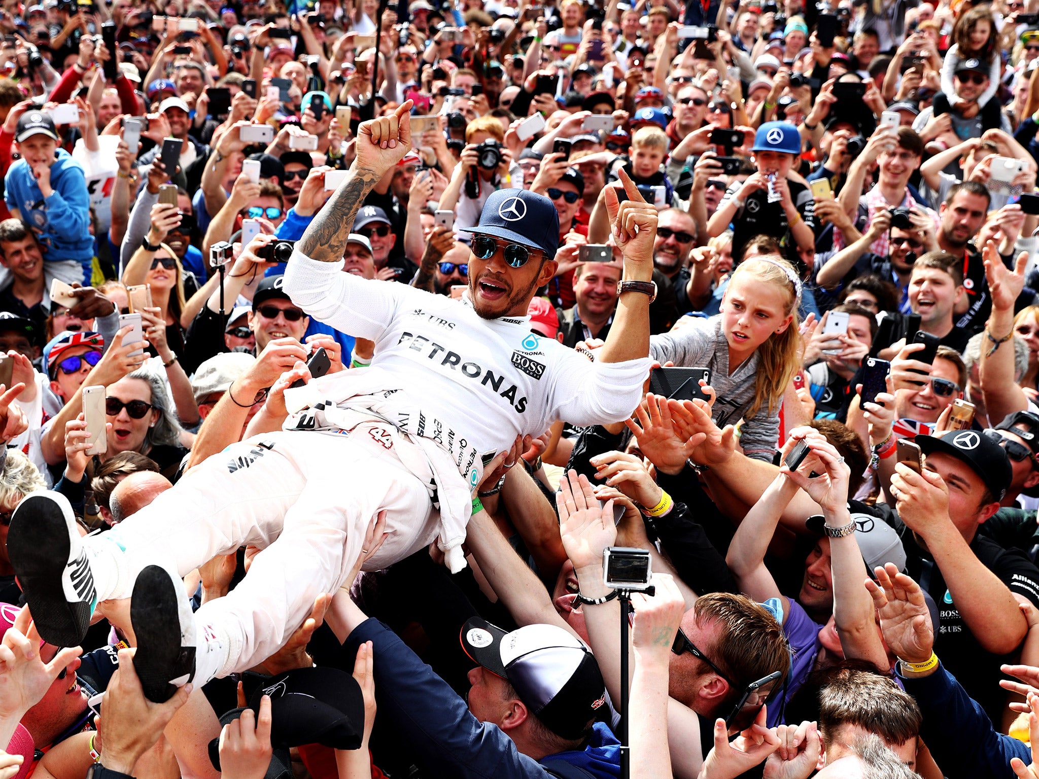 Lewis Hamilton crowd surfs after winning the British Grand Prix