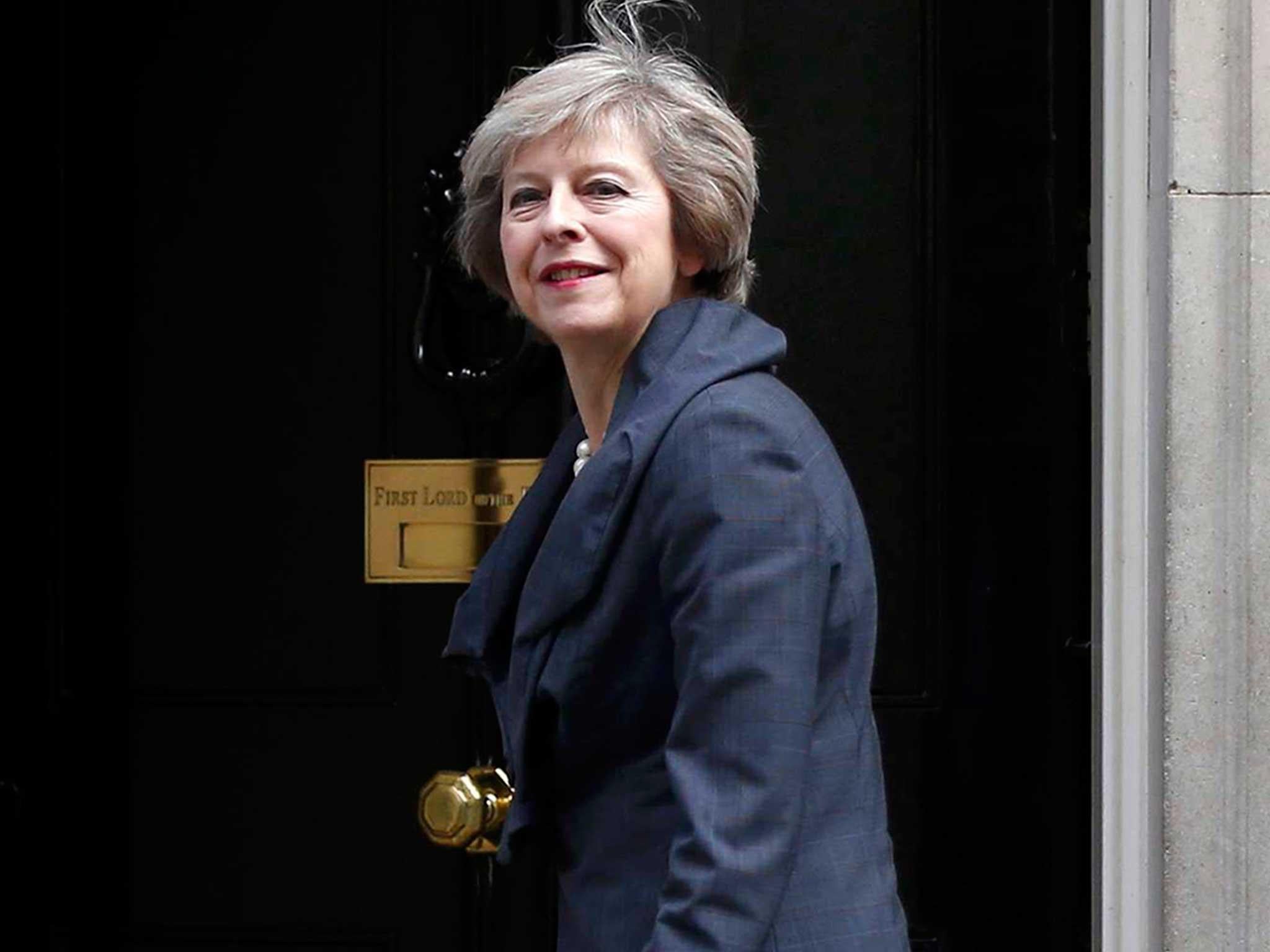 May plans to build more houses and curb executive pay