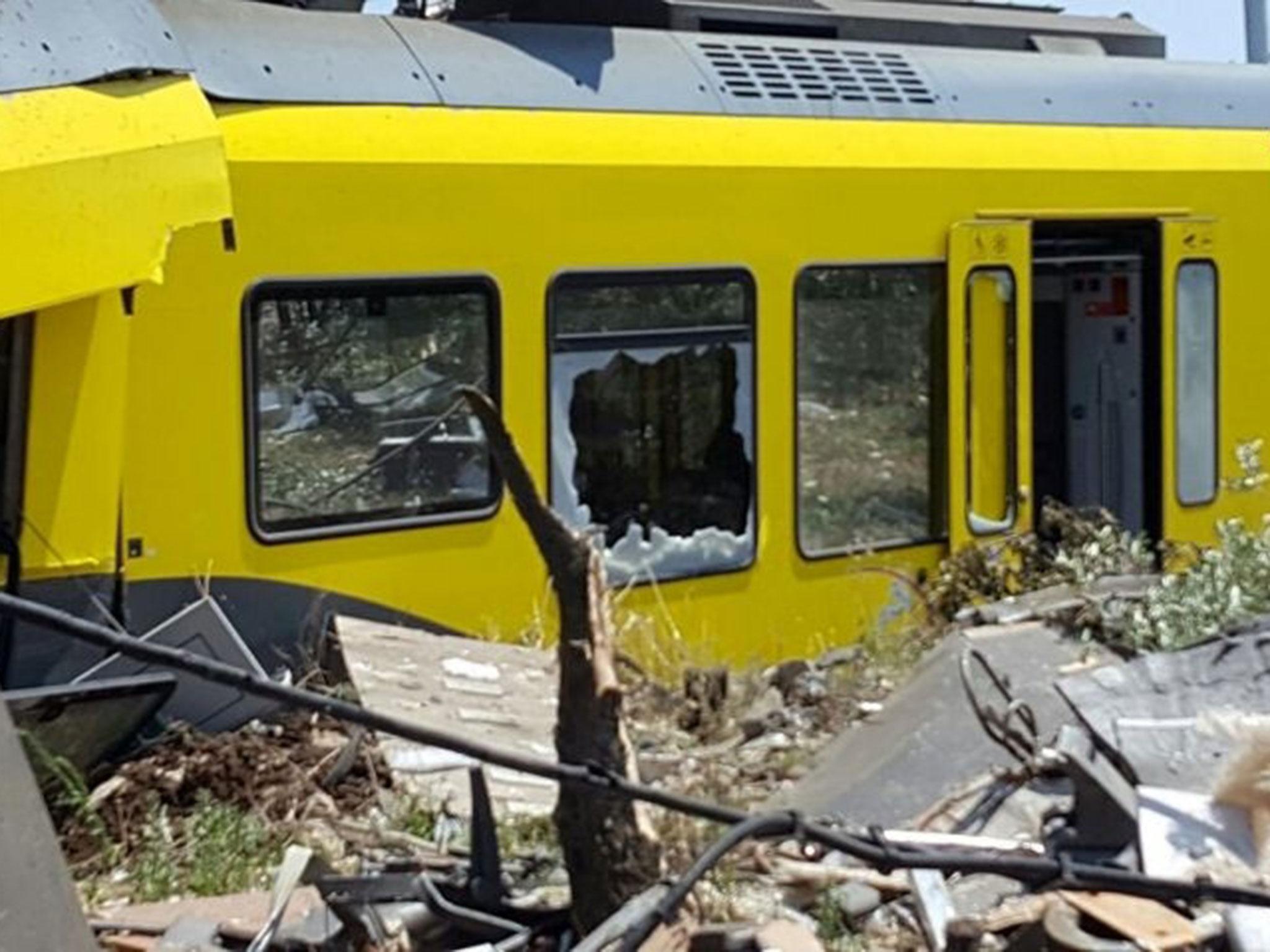 A damaged passenger train is seen after a collision with another in the middle of an olive grove in the southern village of Corato, near Bari, Italy, in this handout picture released by Italian Firefighters, 12 July, 2016