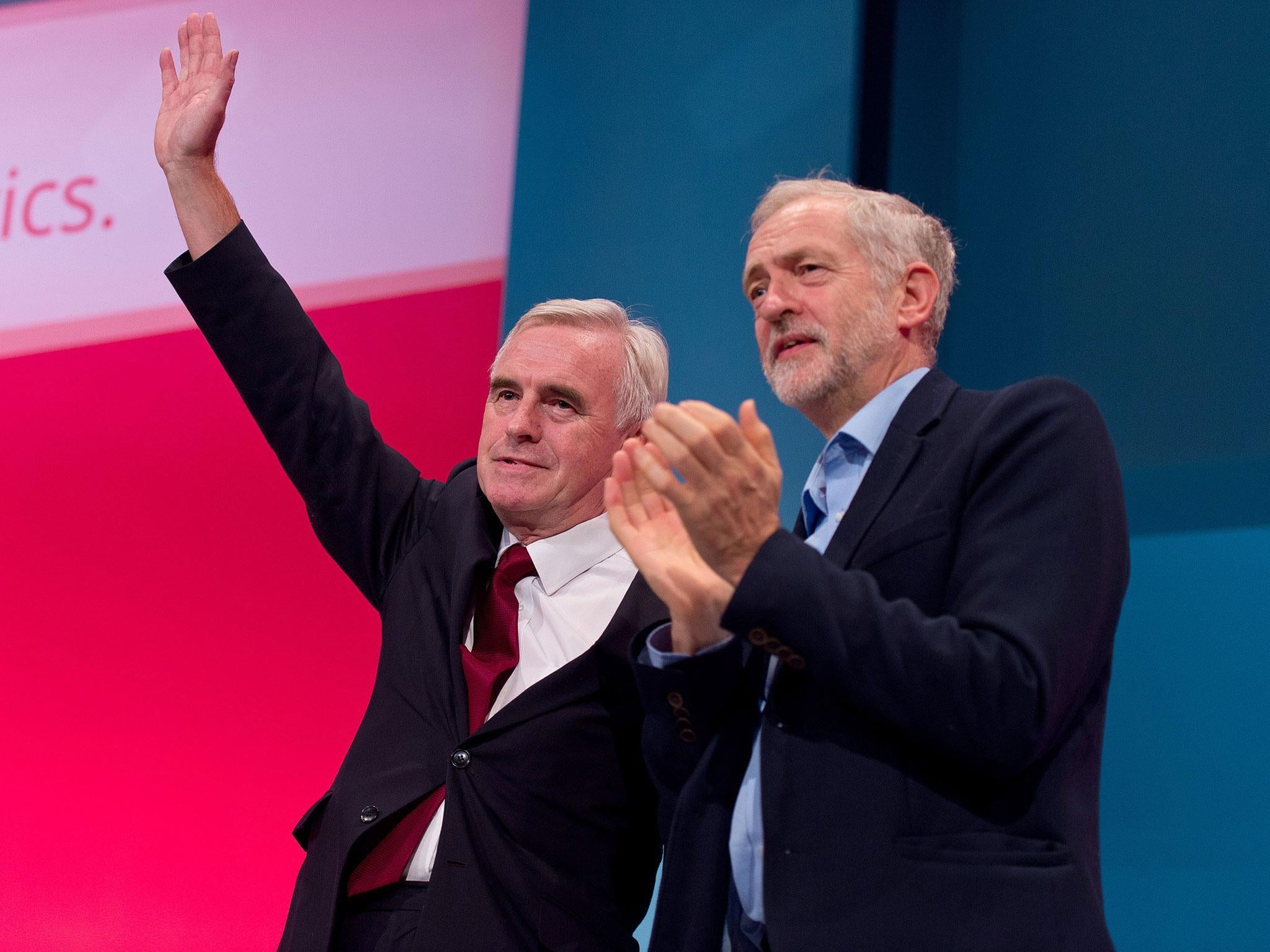 Labour Leader Jeremy Corbyn applaudes Shadow Chancellor John McDonnell after he speaks to delegates in a session entitled 'Stability and Prosperity' during the second day of the Labour Party Autumn Conference on 28 September, 2015 in Brighton, United Kingdom