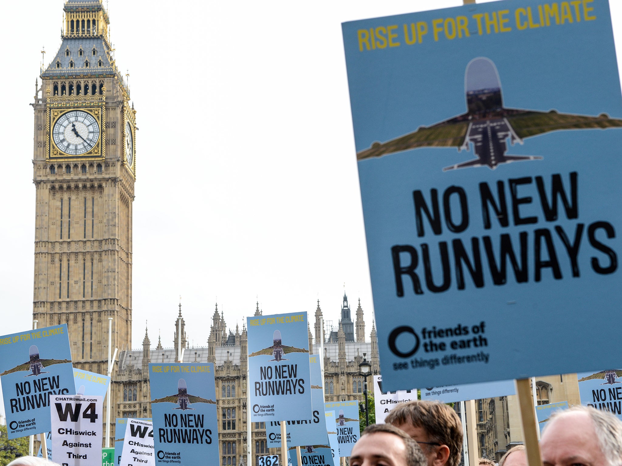 Protesters hold signs during a rally against a third runway at Heathrow last year