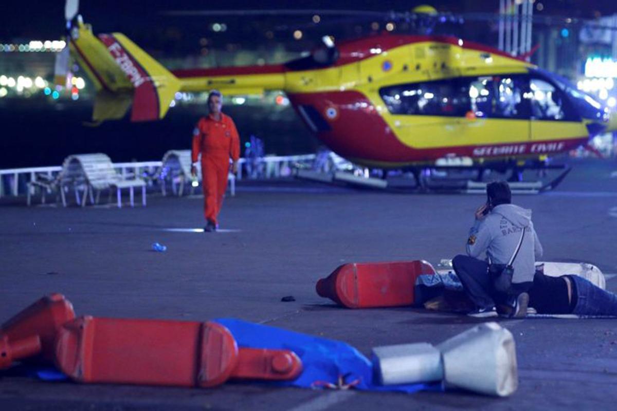 A paramedic attends one of the dozens of people injured in the Nice Bastille Day attack