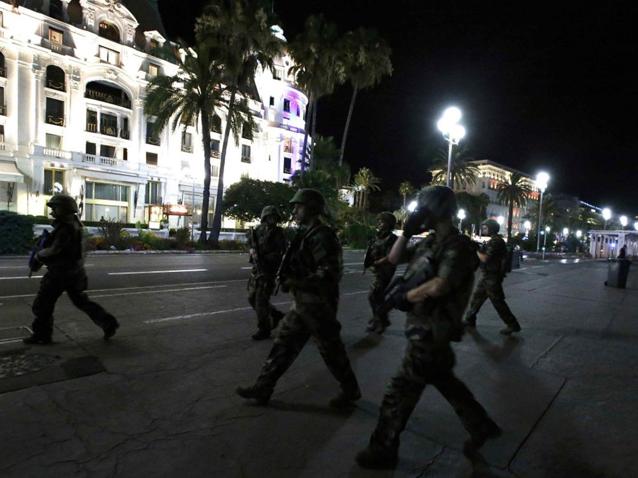 Soldiers march on street where the lorry crashed into the crowd - possibly killing as many as 30 people