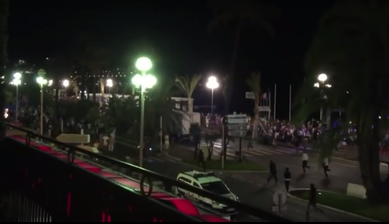 People can be seen running after the lorry, but within seconds it rams into the crowd