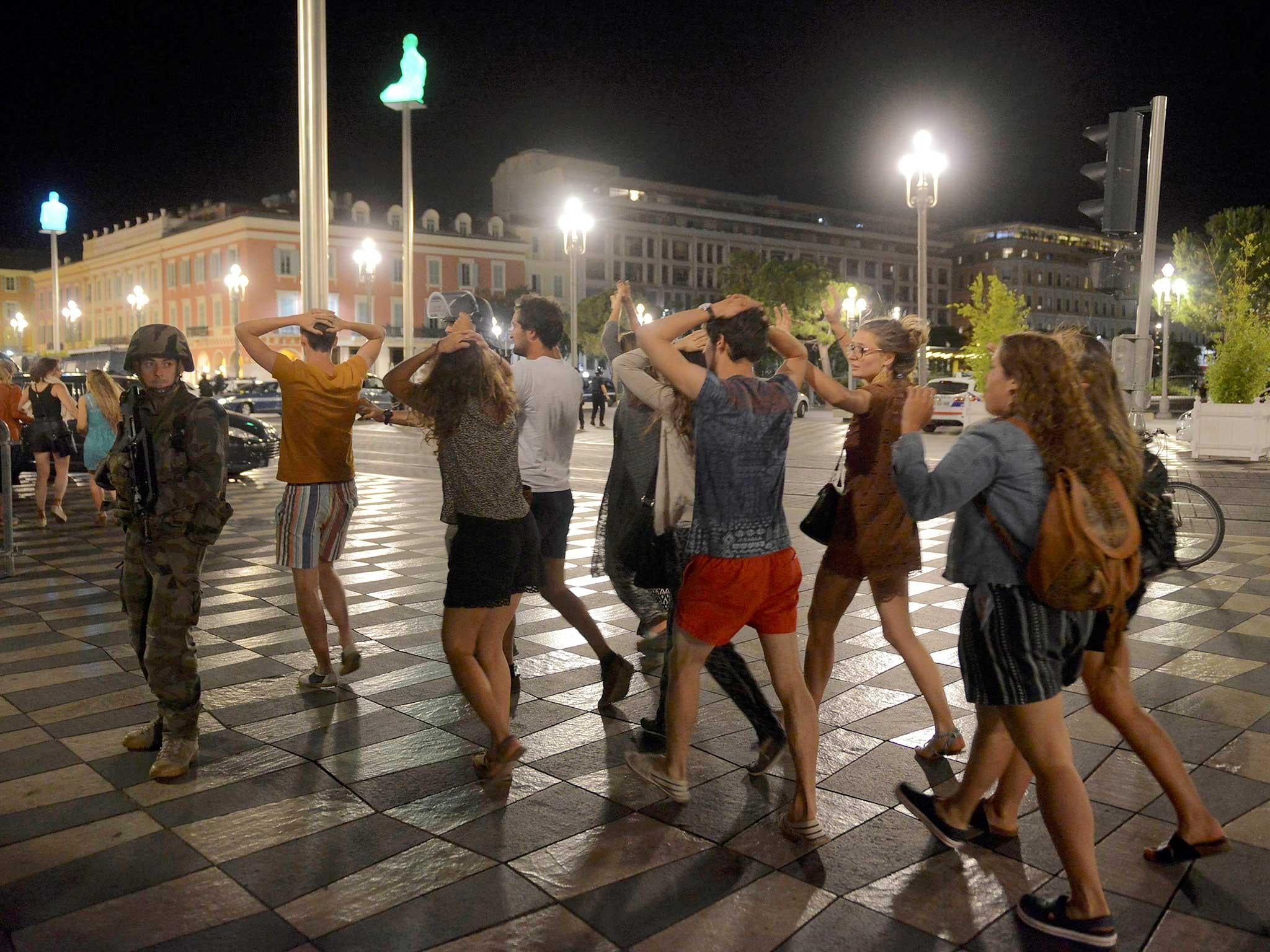 Survivors are shepherded away from the scene of the attack at the Promenade des Anglais