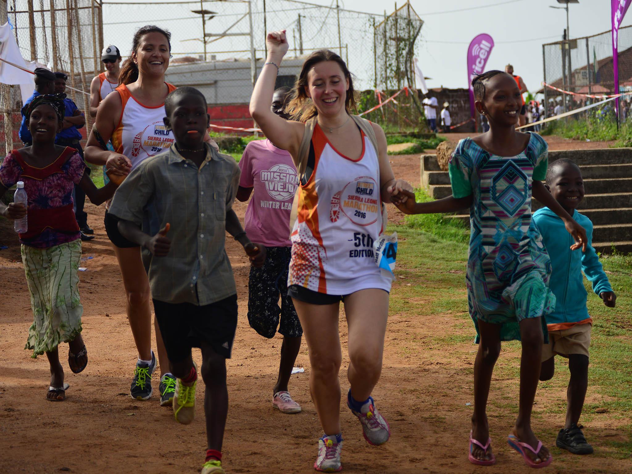 
Runners crossing the finish line holding hands 