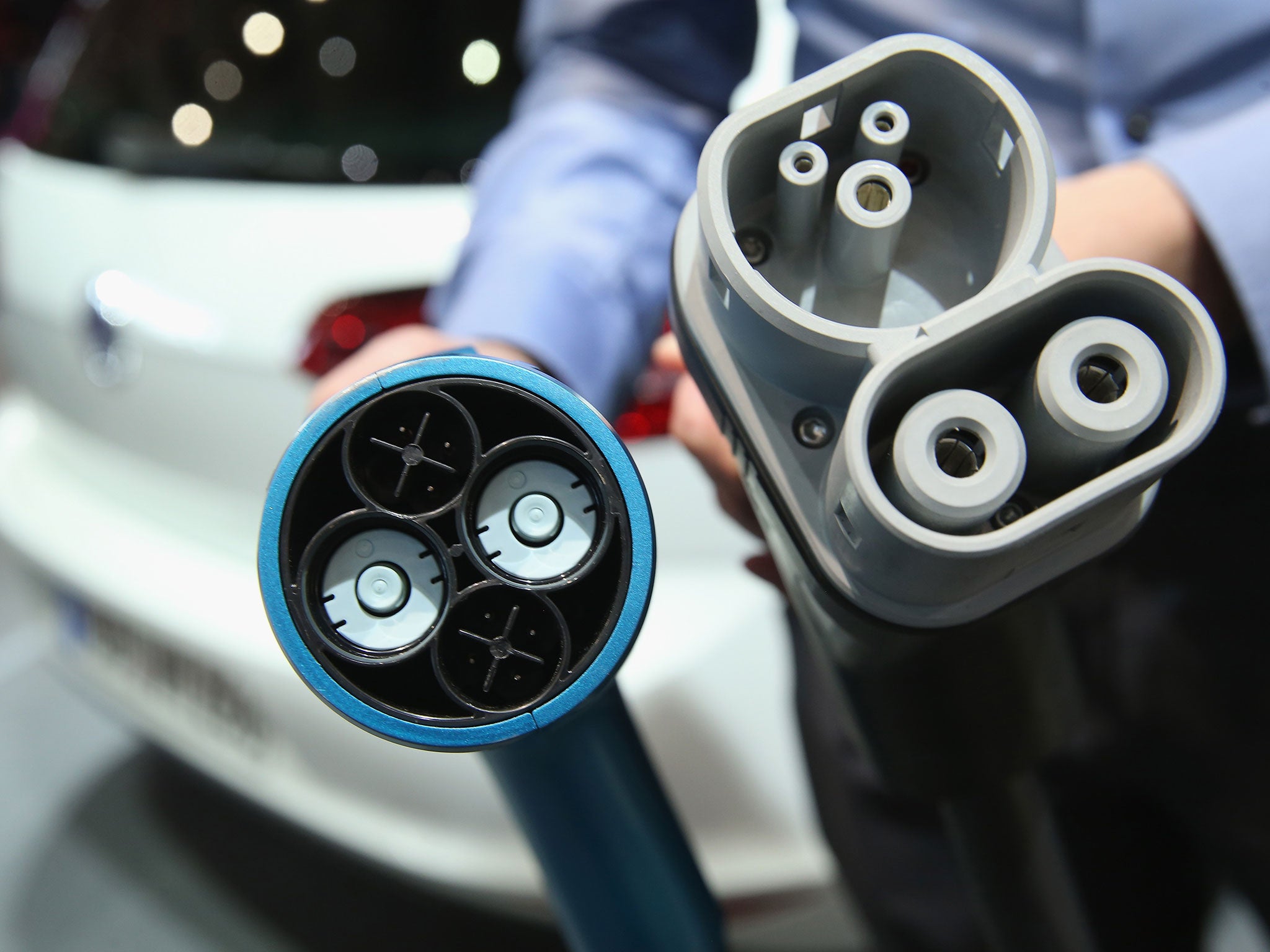 Two different kinds of electric car charging plug interfaces, the left more common in Japan and the right more common in Germany (Getty)