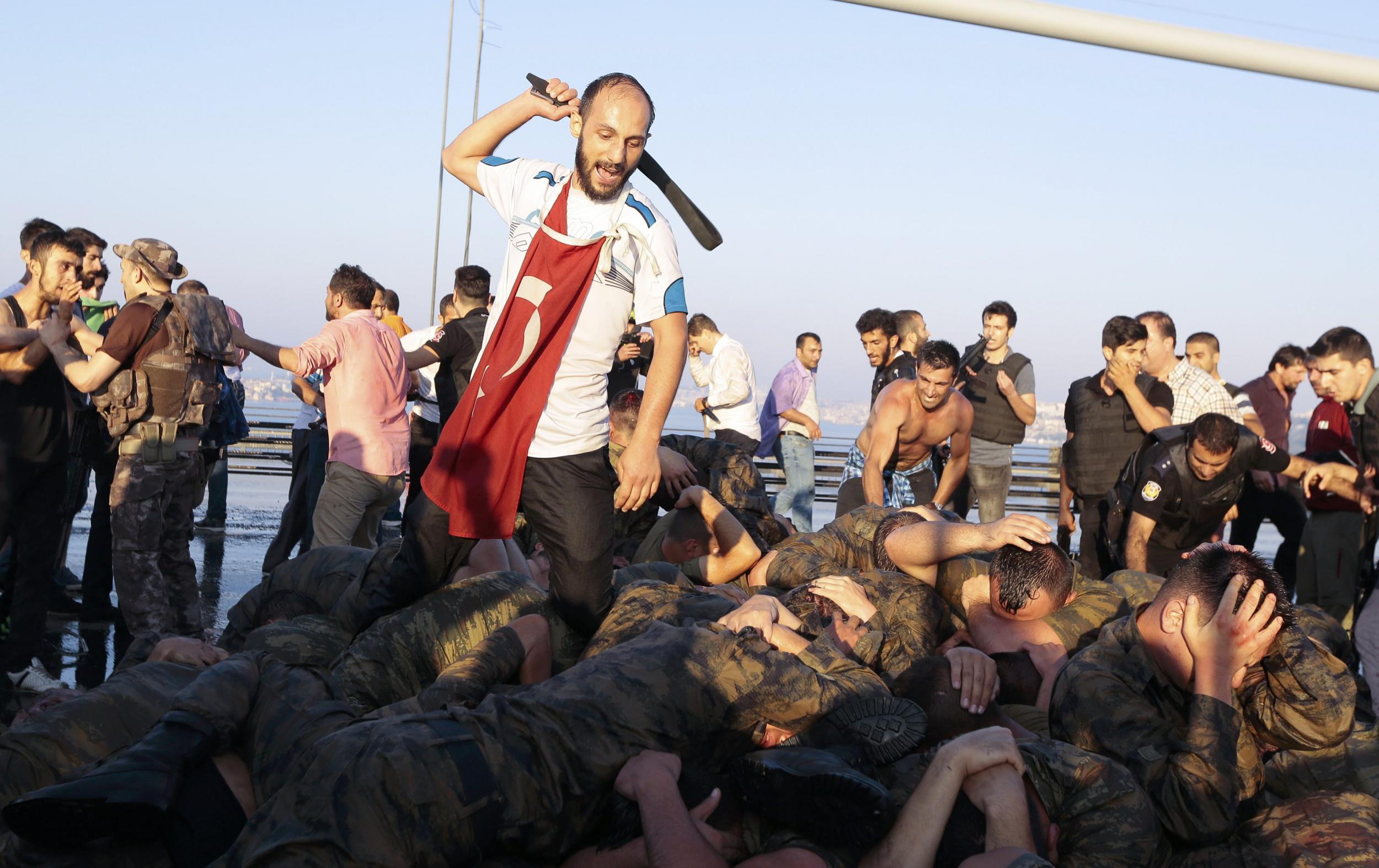 Surrendered Turkish soldiers who were involved in the coup are beaten by a civilian