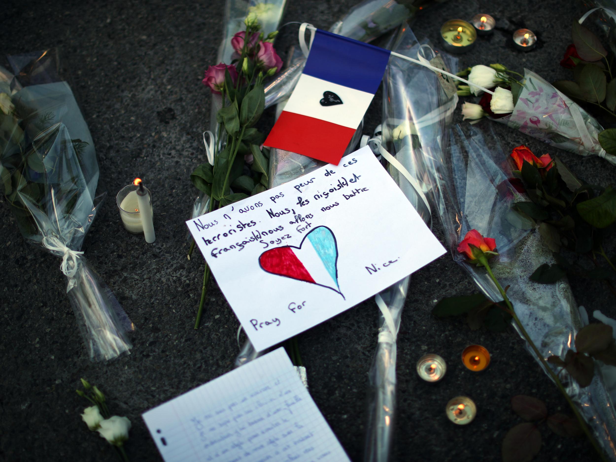 A tribute is laid on the ground where a person was killed on the Promenade des Anglais, Nice