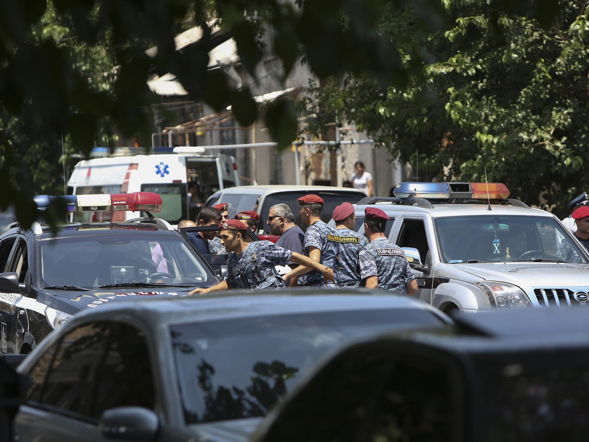 Armenia security forces say a group of armed men has attacked a central police station in the Armenian capital, killing one officer, wounding two and taking others hostage