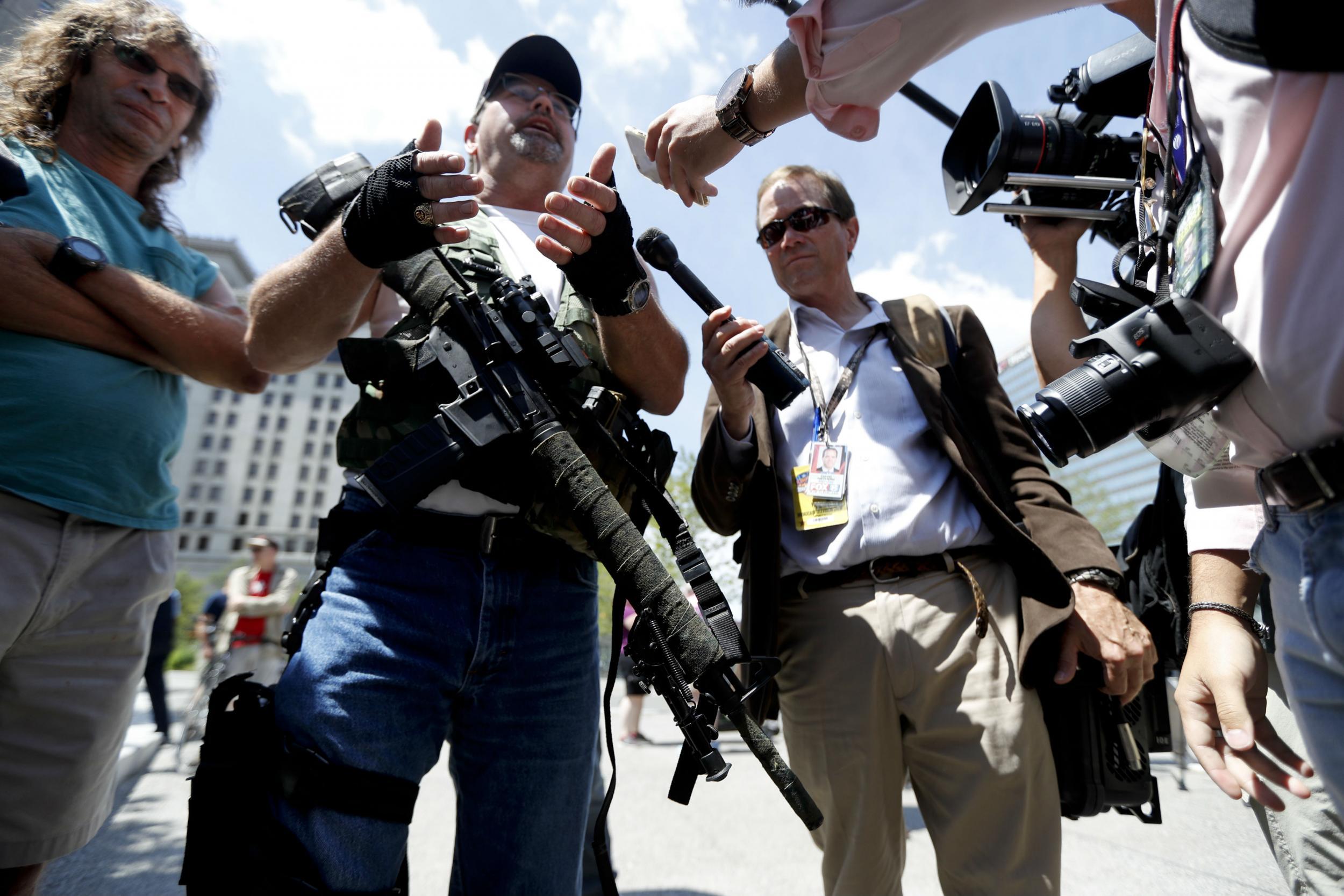 A gun rights advocates shows off his weapons on Sunday