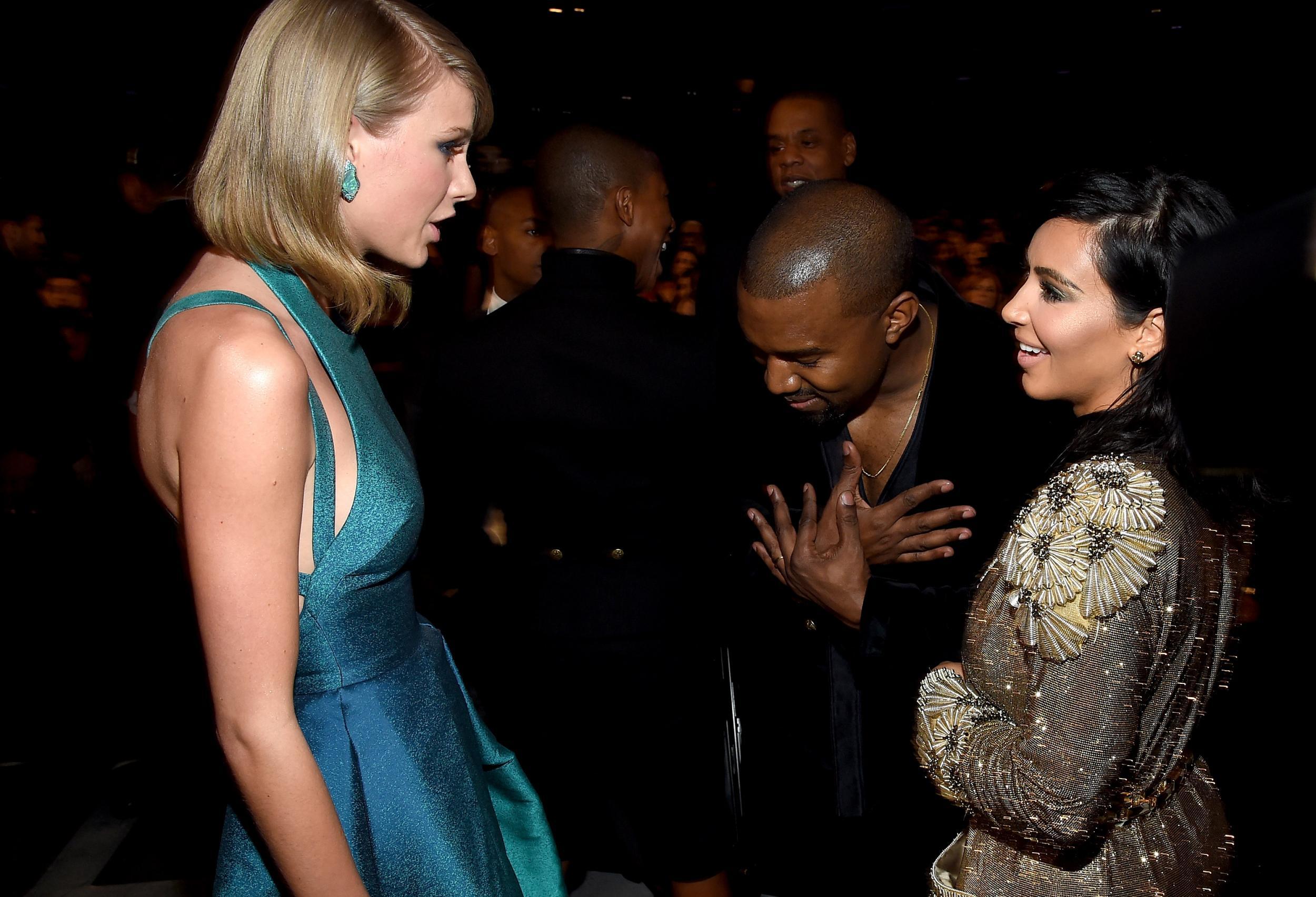 Taylor Swift, Kanye West and Kim Kardashian chat at the Grammy awards in February, 2015