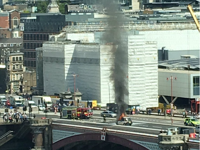 Black smoke can be seen coming out of the taxi