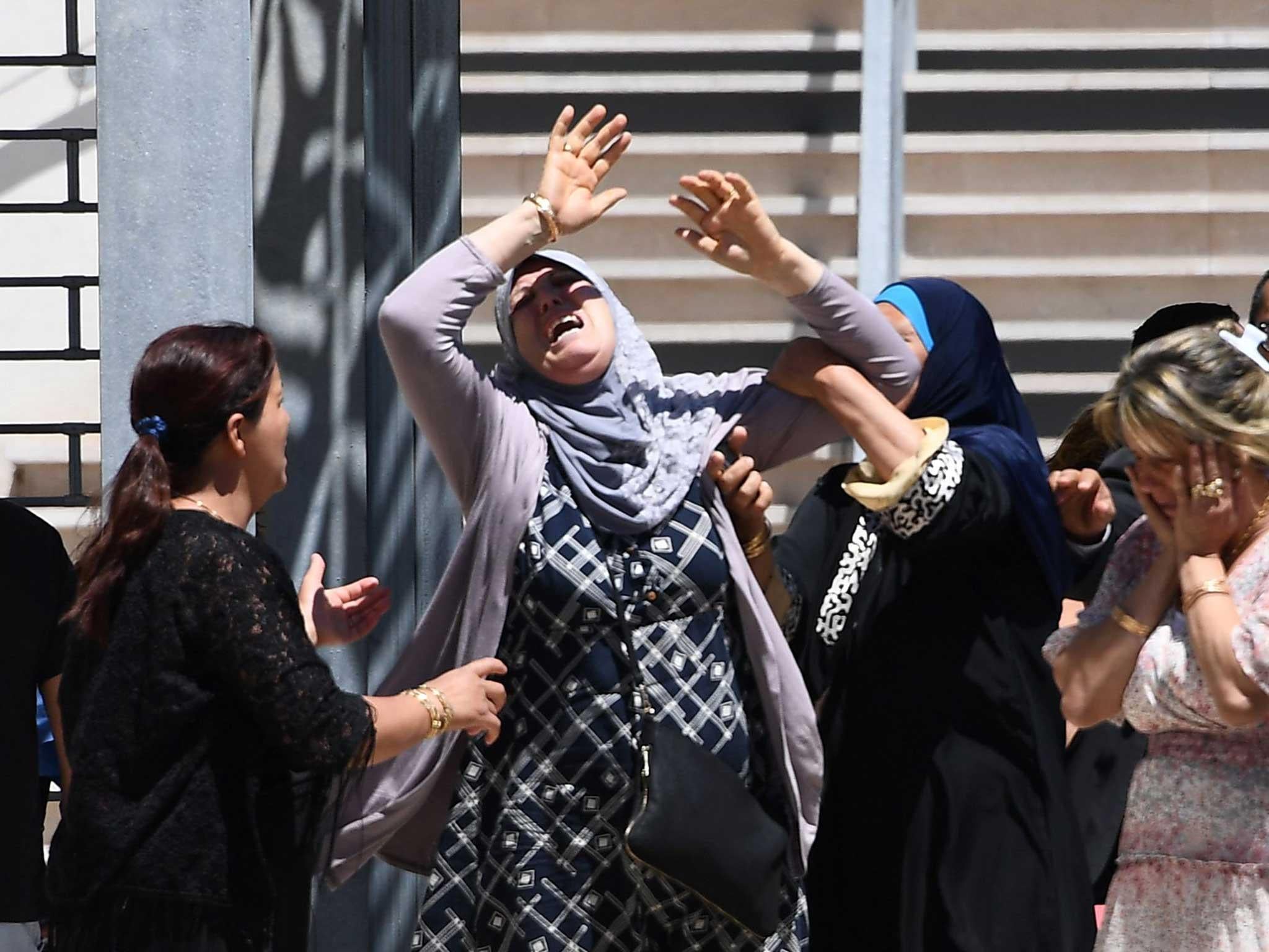 A woman reacts to the news of the death of her grandson in Nice