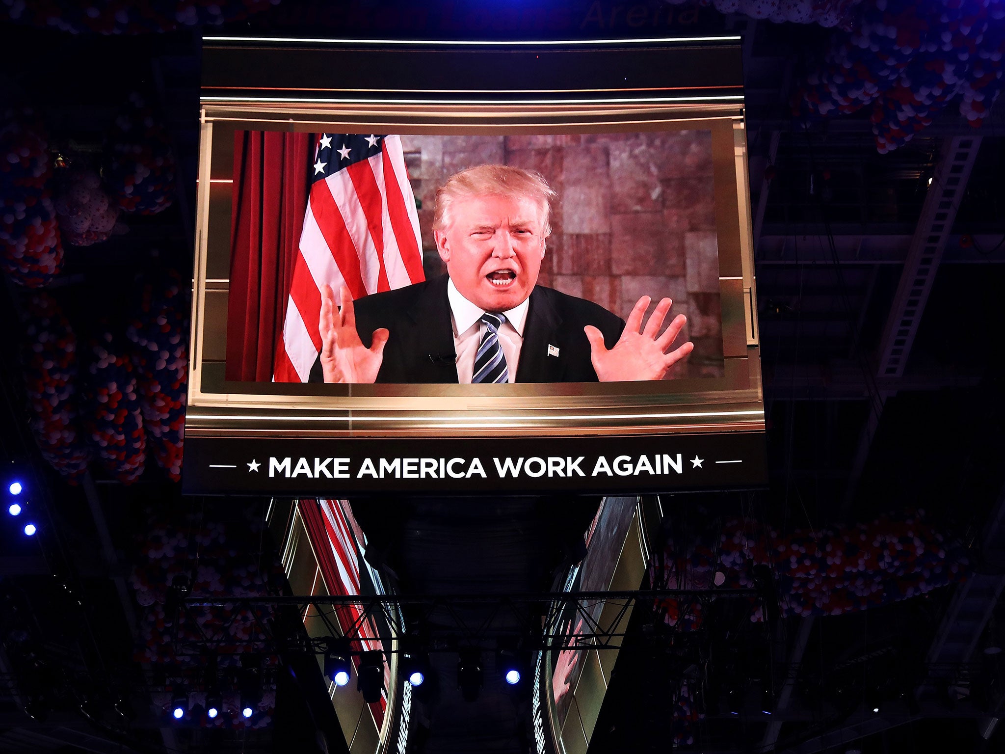 Republican presidential candidate Donald Trump is seen speaking on a screen from New York City, on the second day of the Republican National Convention on July 19, 2016