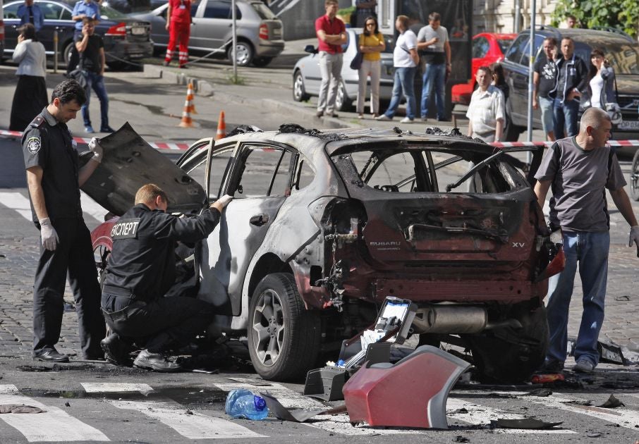 Police inspect the car of dead journalist Pavel Sheremet in Kiev