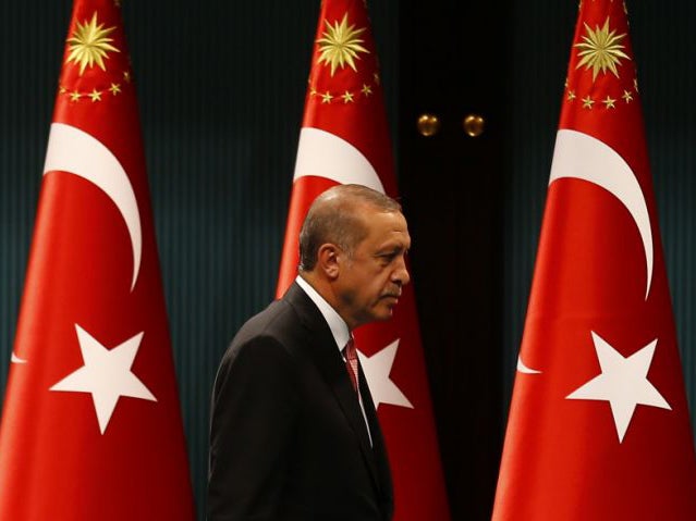 Turkish President Tayyip Erdogan leaves after a news conference following the National Security Council and cabinet meetings at the Presidential Palace in Ankara, Turkey