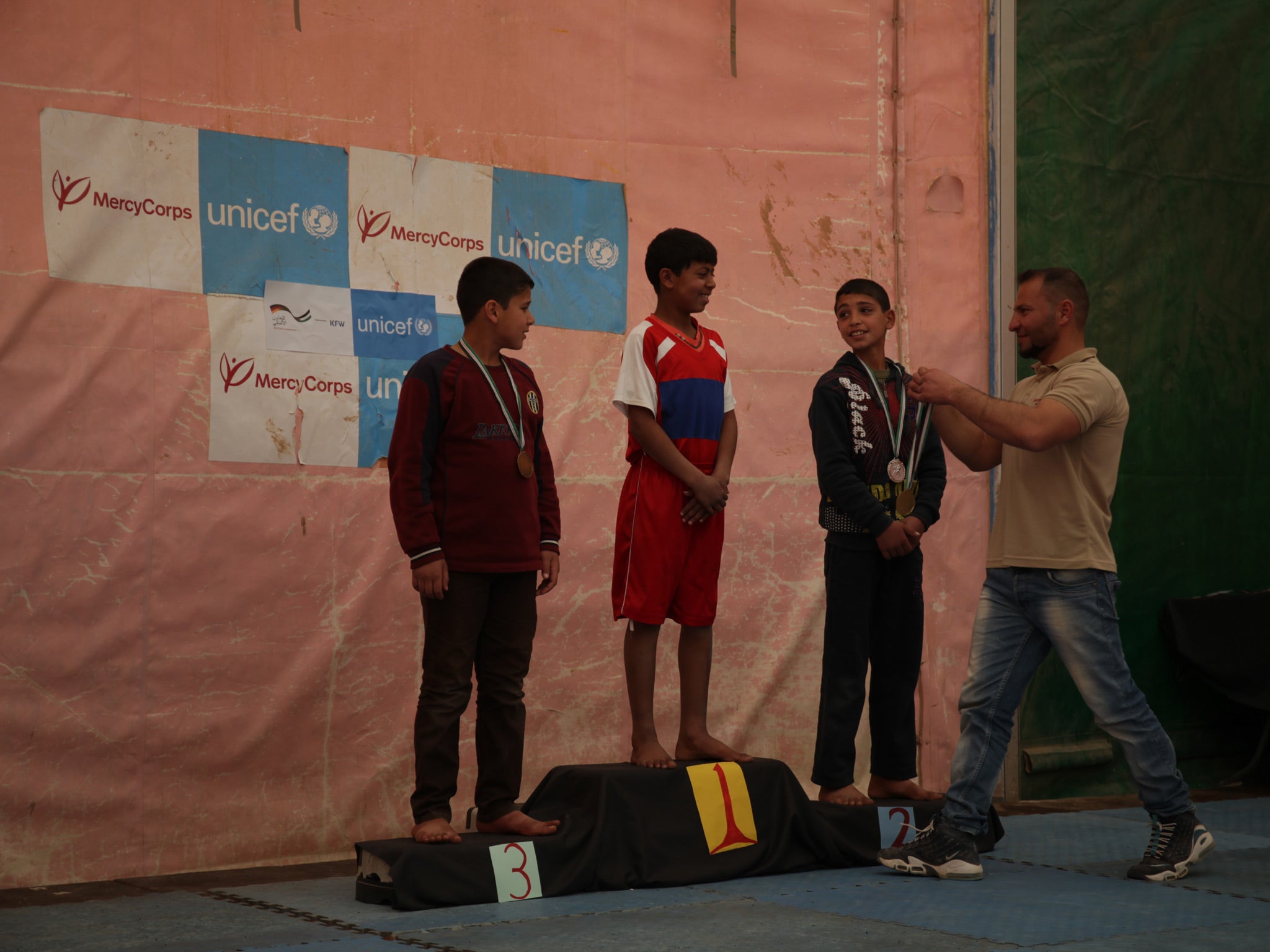 Charities organise activities for the camp's children, like this wrestling competition