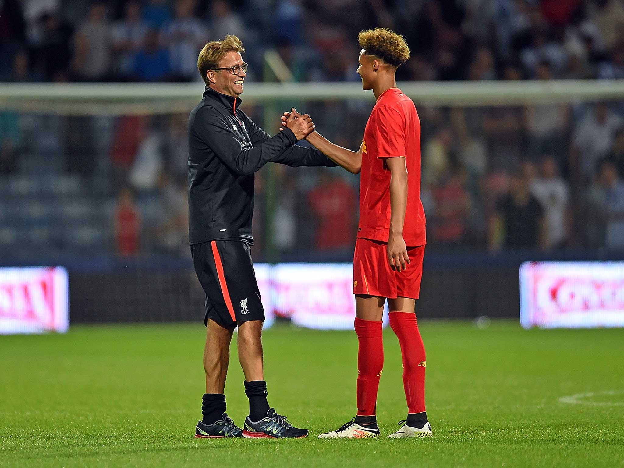 Liverpool manager Jurgen Klopp embraces goalkeeper Shamal George after he played up front in the friendly win against Hudderfield