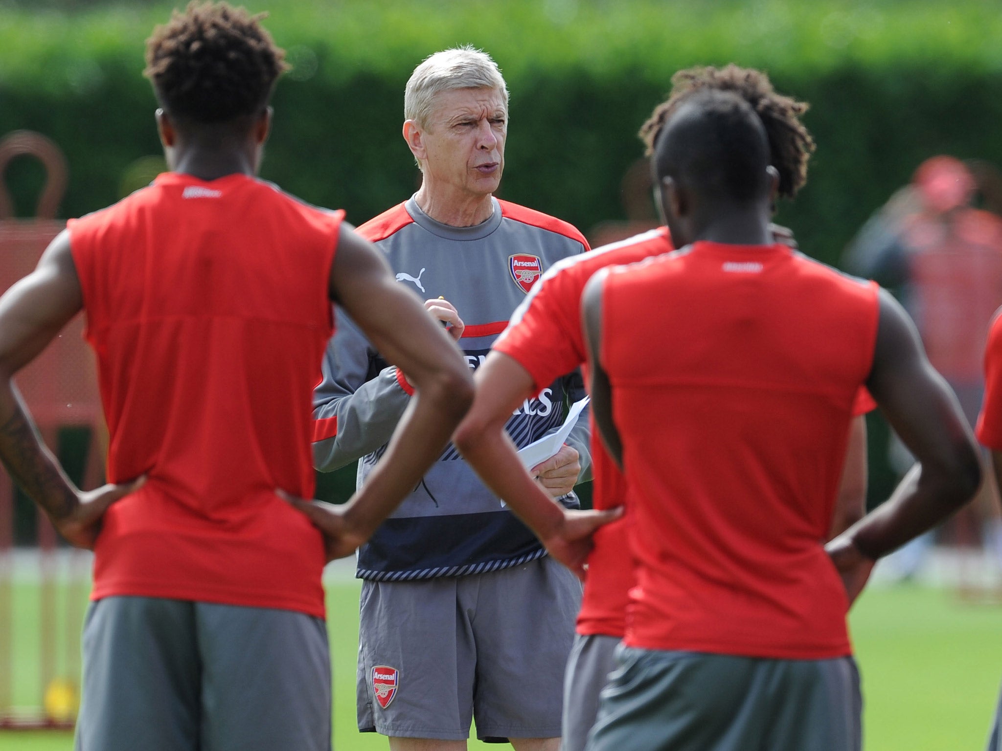 Arsene Wenger leads his side through pre-season training