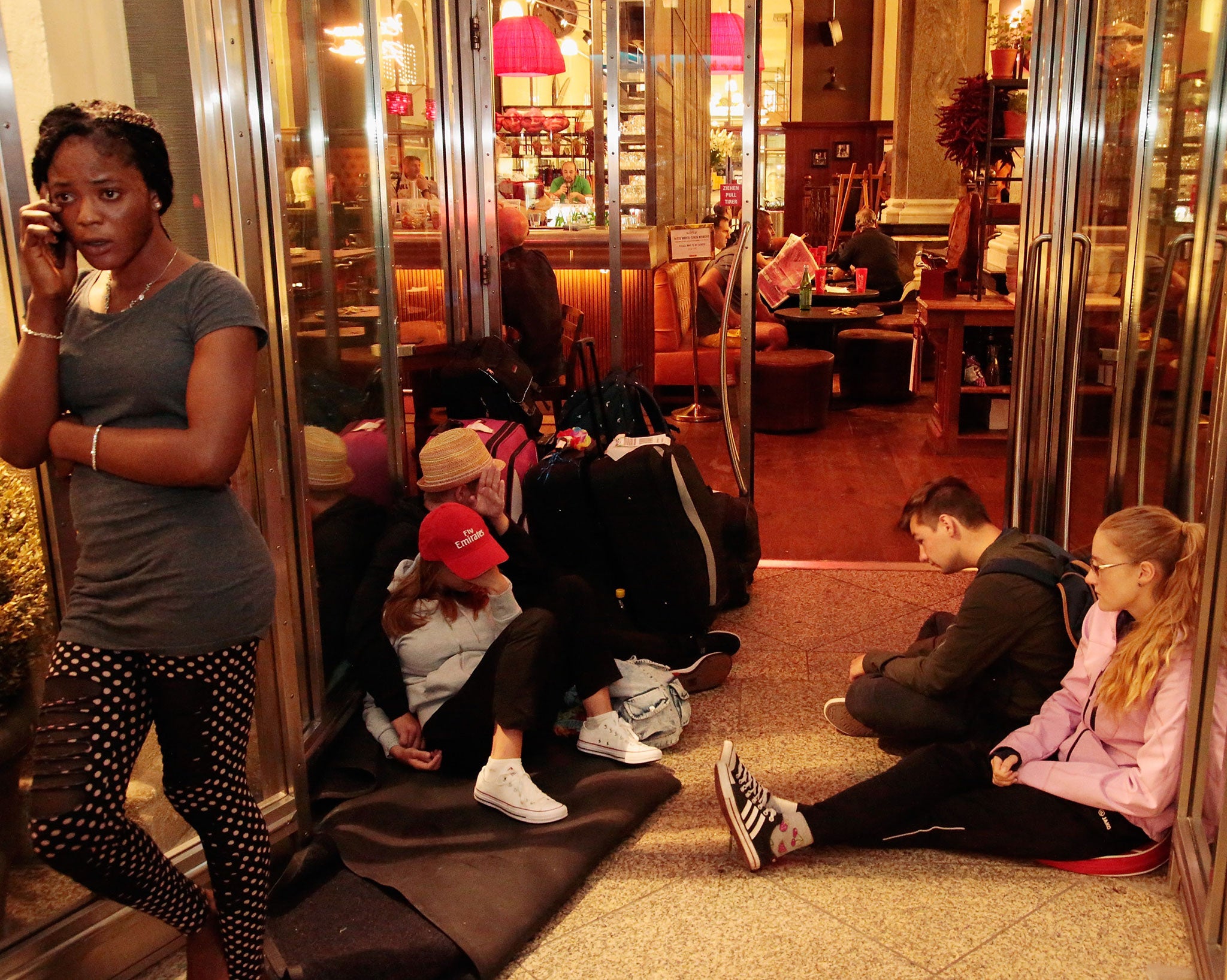 Stranded tourists wait in front of Munich Central station