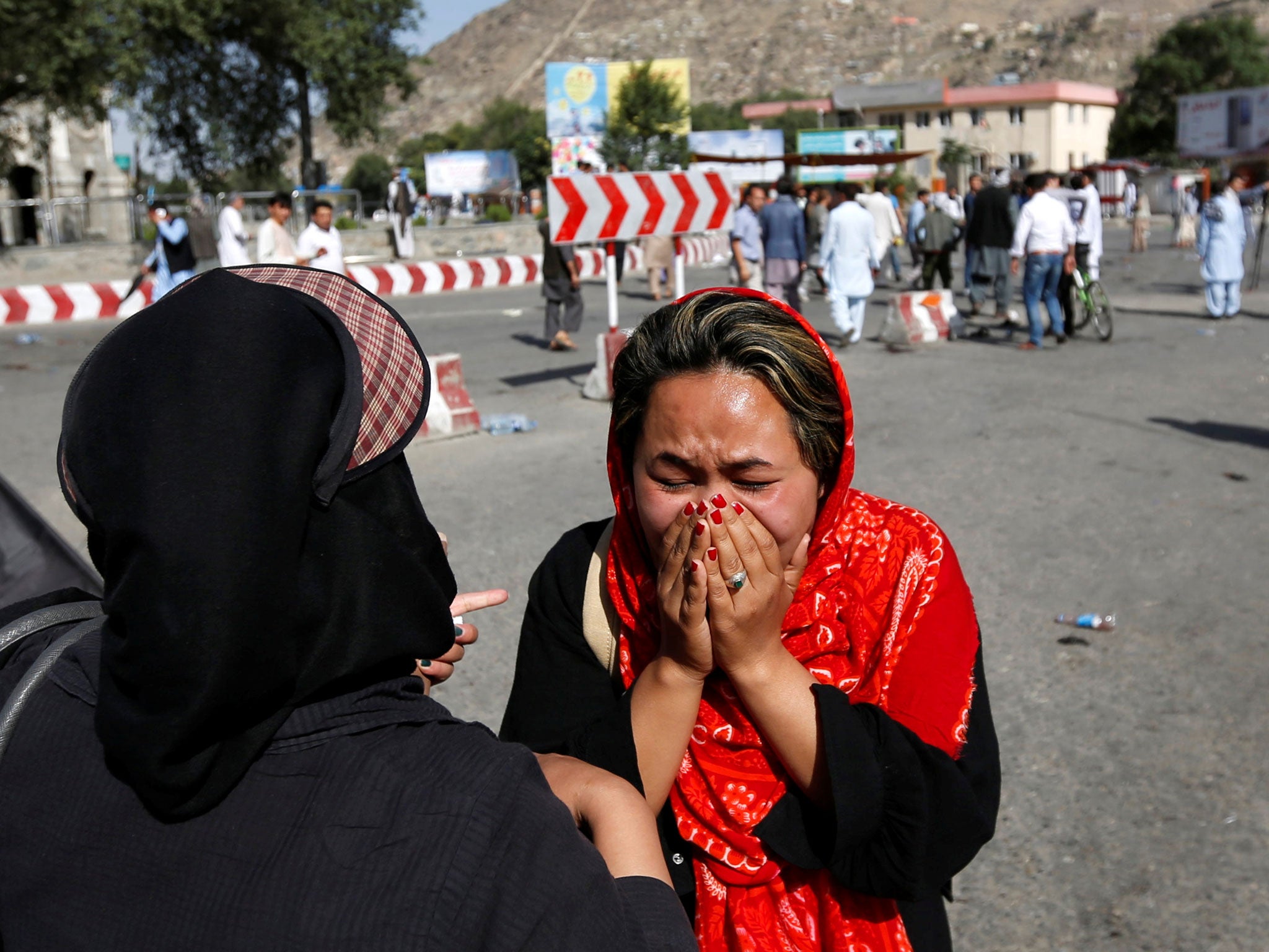 An Afghan woman weeps at the site of a suicide attack in Kabul