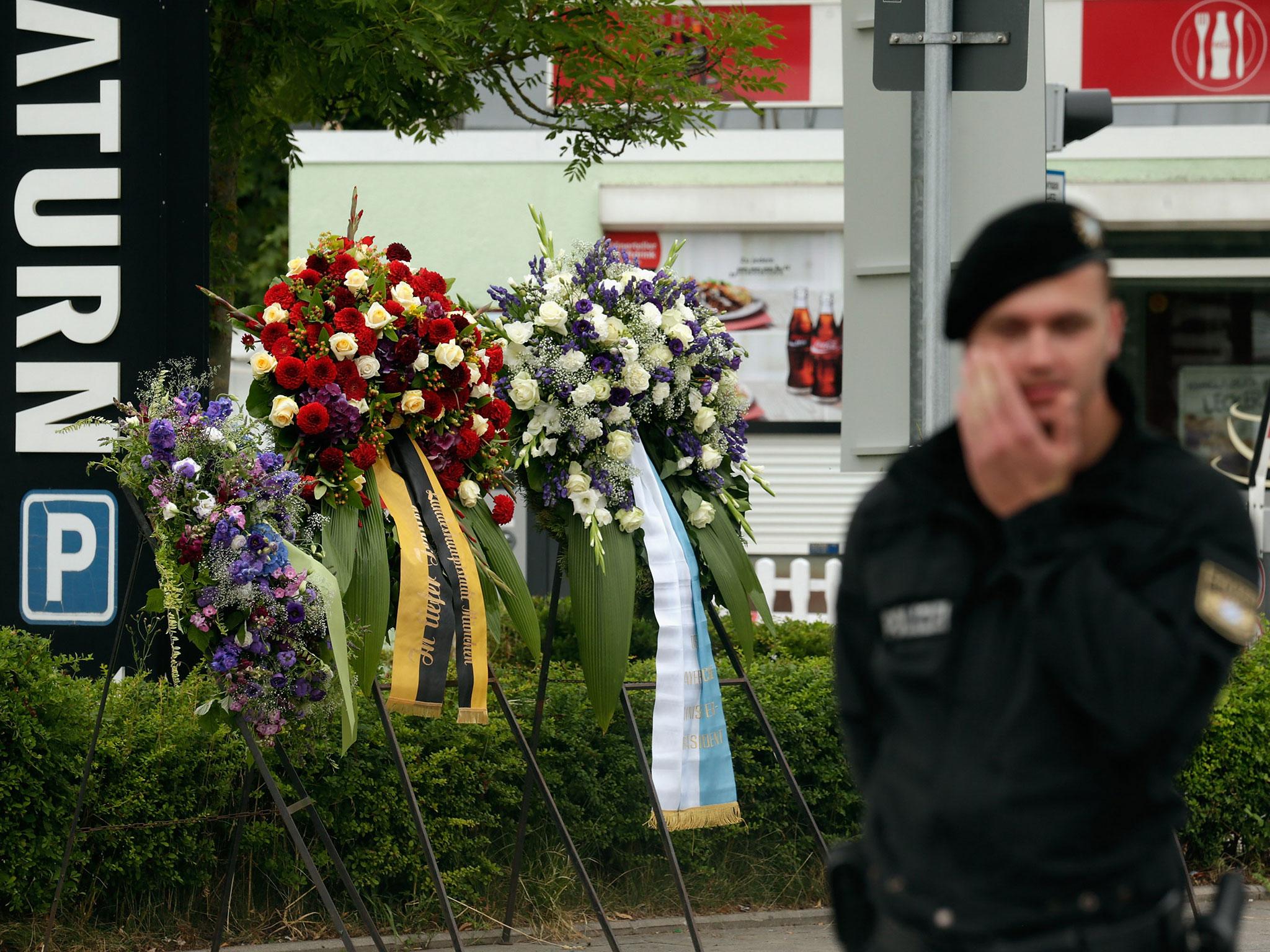 A police officer guards the scene of the attack which left nine people dead