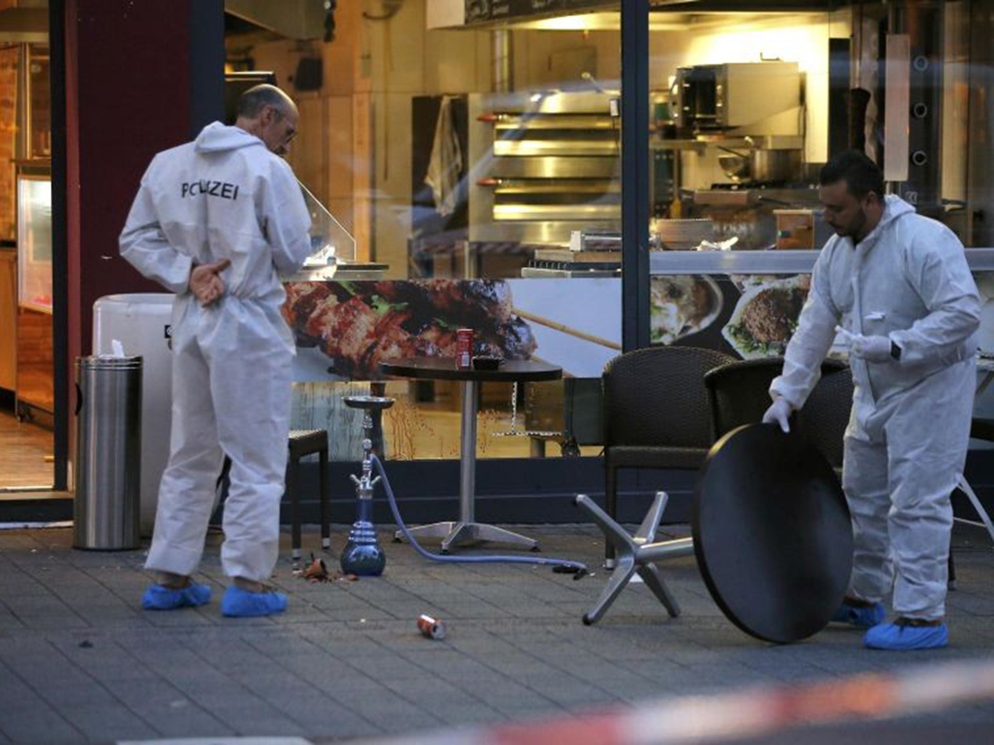 Forensics at the scene following the attack outside the restaurant in Reutlingen