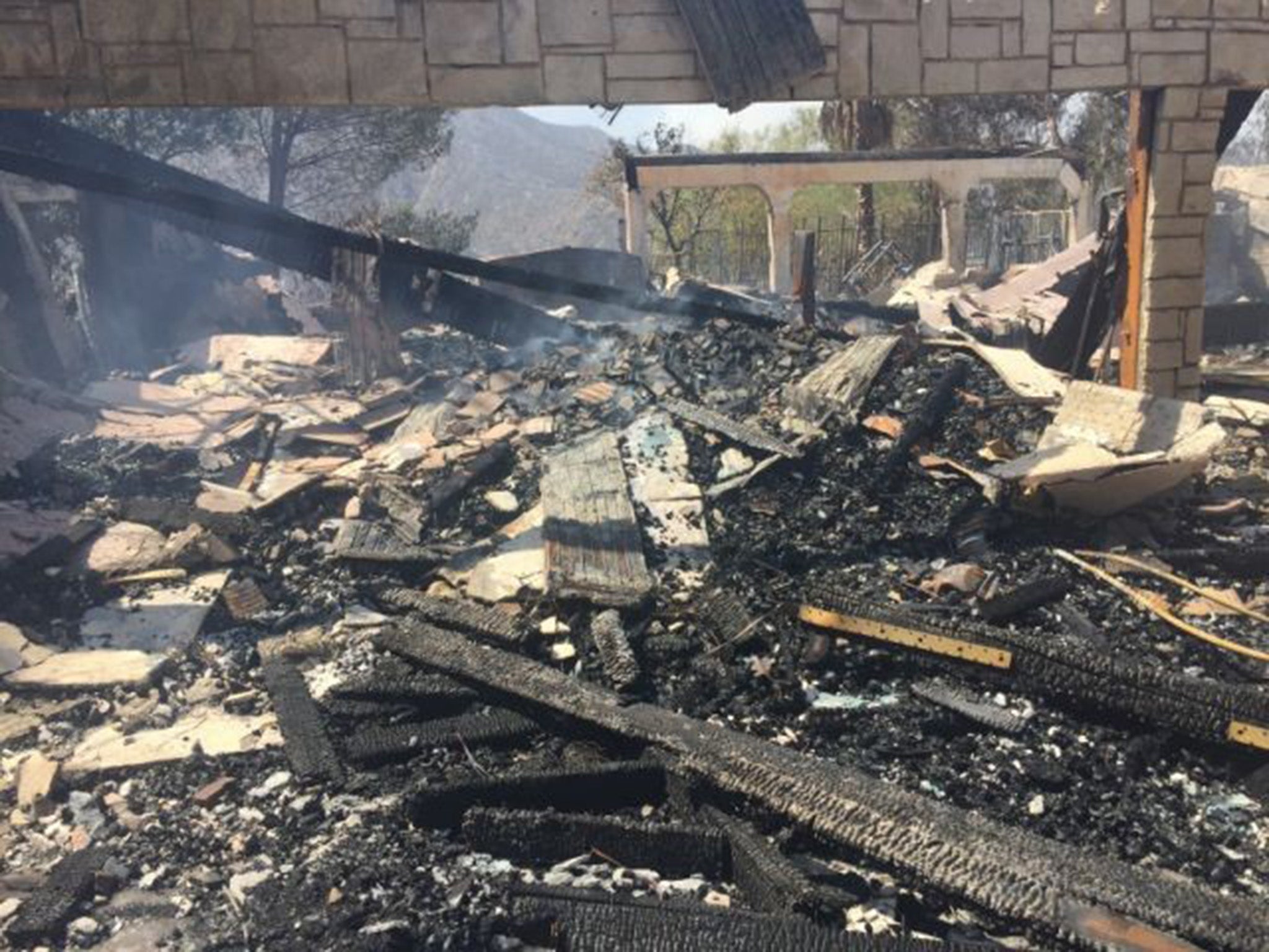 The remains of a home destroyed by fire in Santa Clarita. Over 1,000 homes are at risk