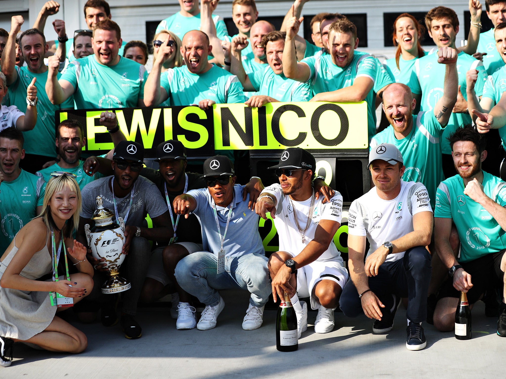 Hamilton and Rosberg posed for the traditional post race team photograph