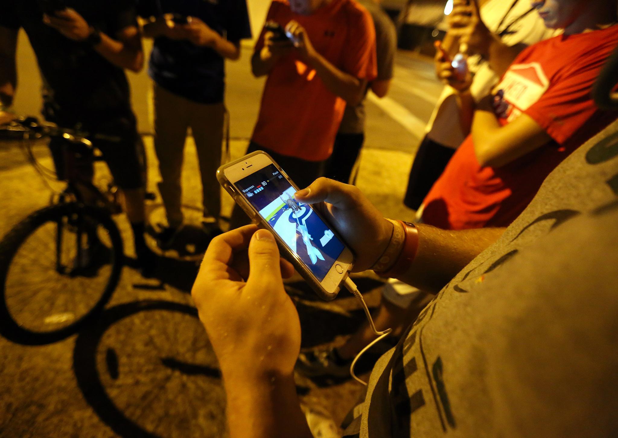 A group of teenagers play "Pokemon Go"