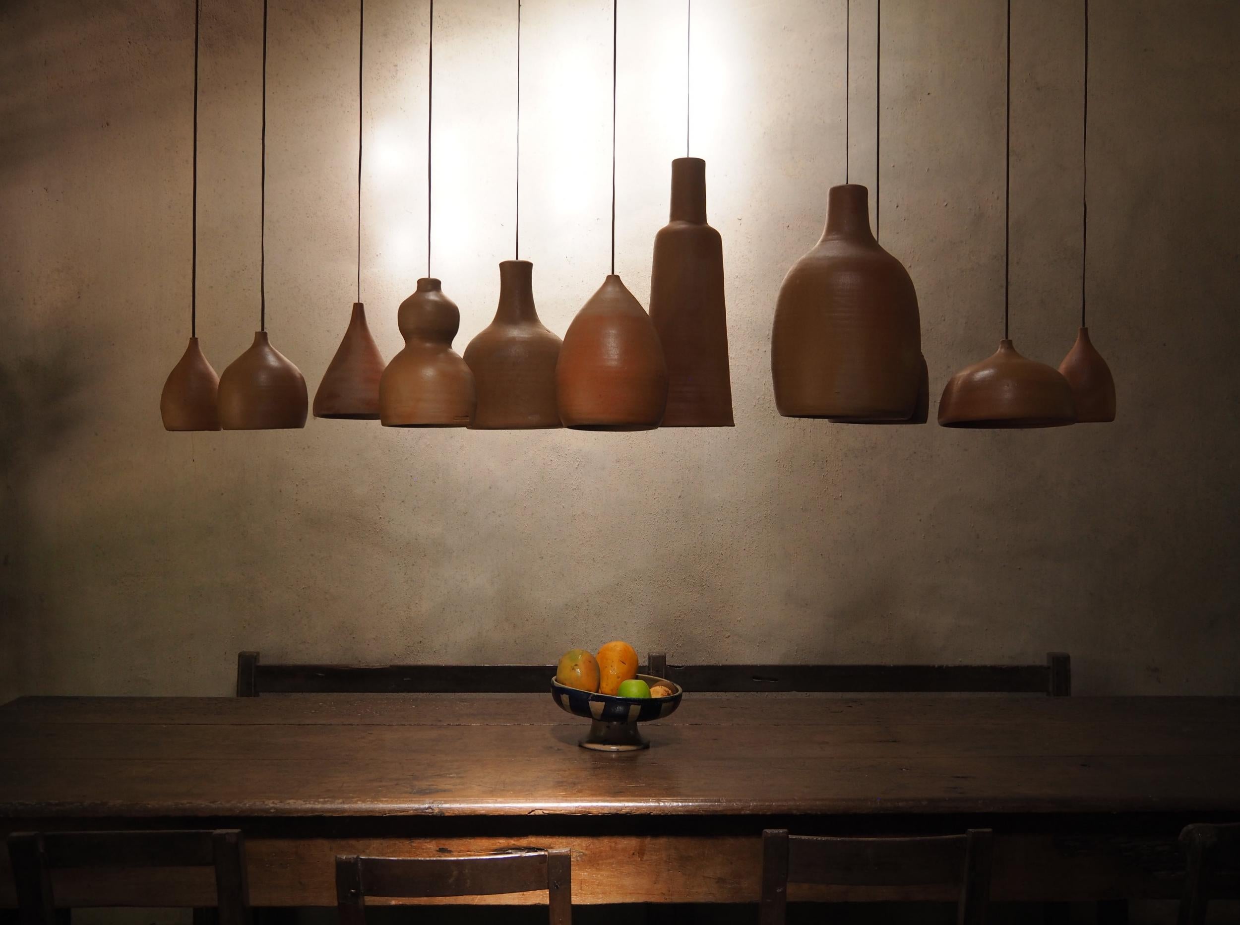 At a breakfast table at the UXUA Casa Hotel, light shades crafted from indigenous clay and hung above a clean-lined wood table, feel simultaneously primitive and modern, much like Brazil itself