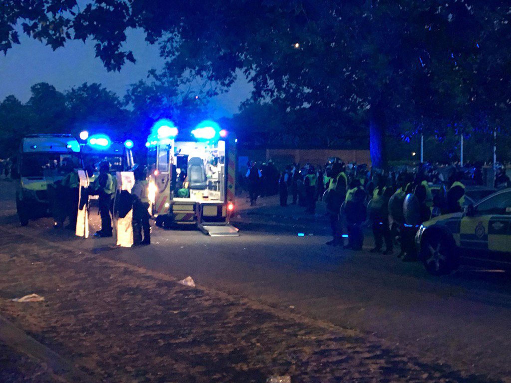 Police officers in riot gear gather at Hyde Park on the night of the disorder