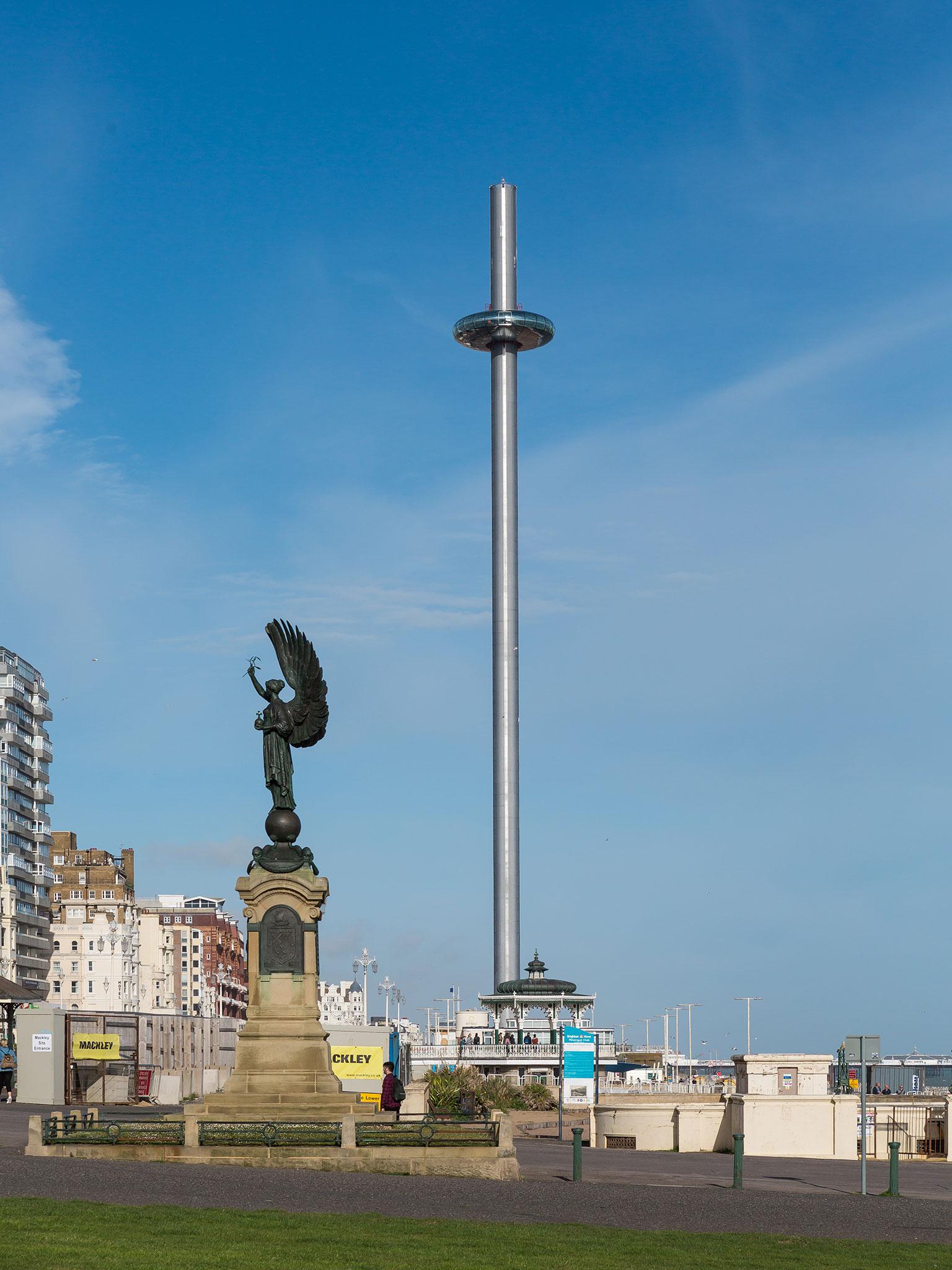 The i360 as it stands beside the Peace Statue on Brighton seafront.