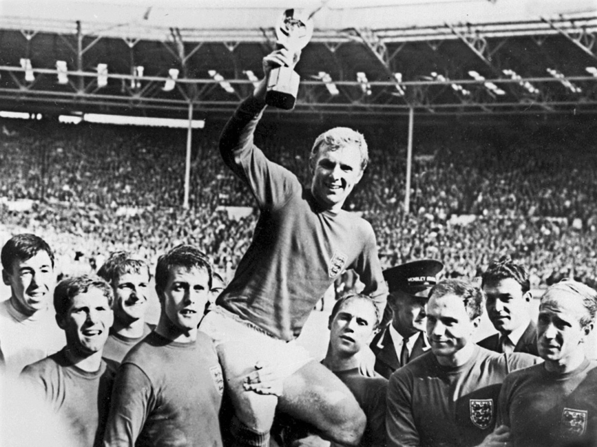 Bobby Moore is hoisted onto the shoulders of his England teammates with the World Cup trophy