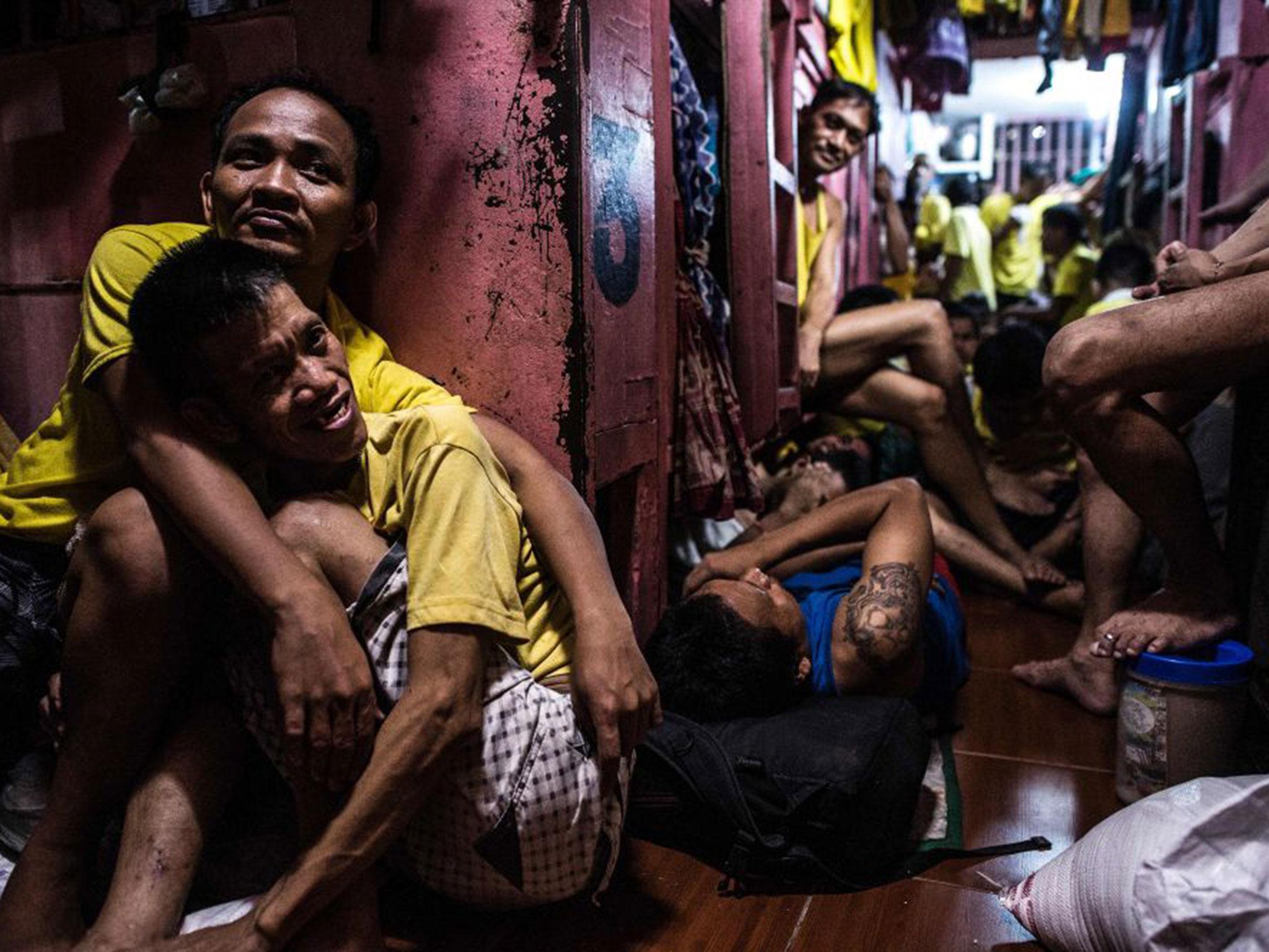 Inmates rest in their sleeping quarters (AFP/Noel Celis)